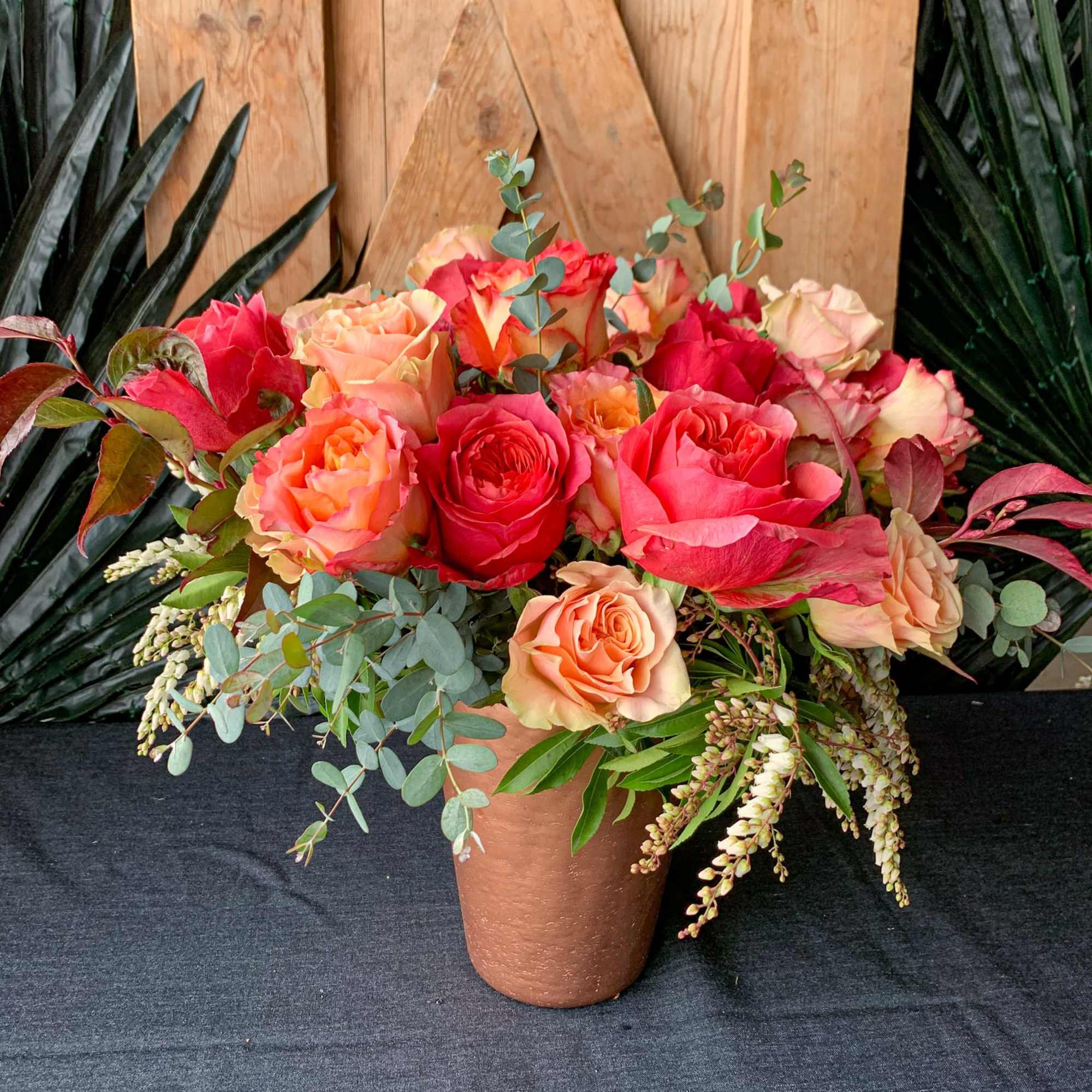 Bouquet of pink and peach roses in a terracotta vase