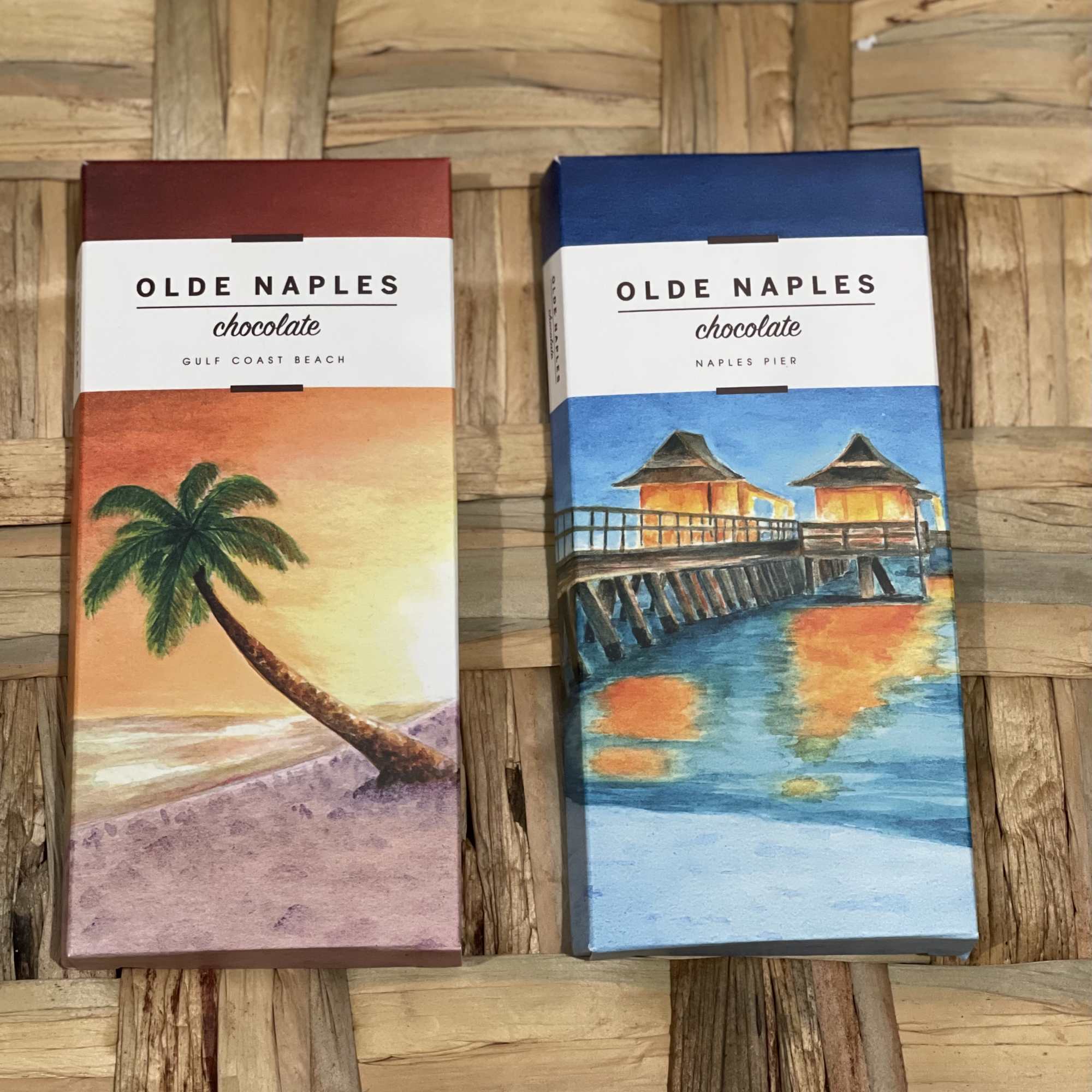Two Olde Naples chocolate bars in colorful beach-themed boxes