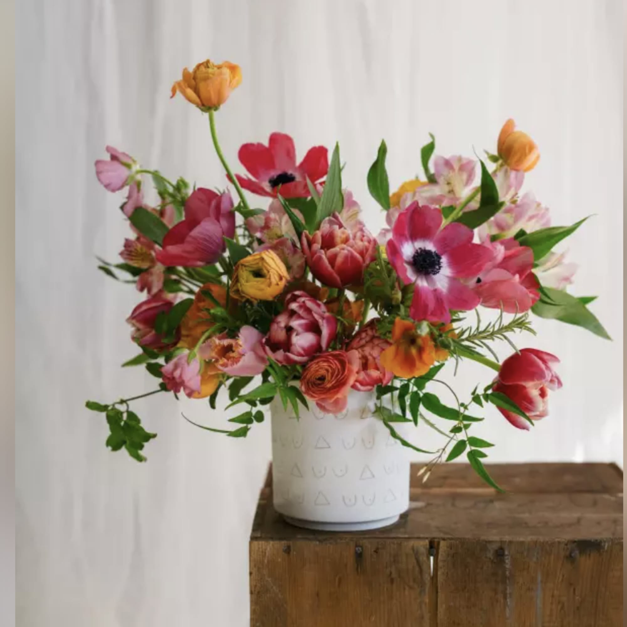 Bright mixed bouquet in a white vase