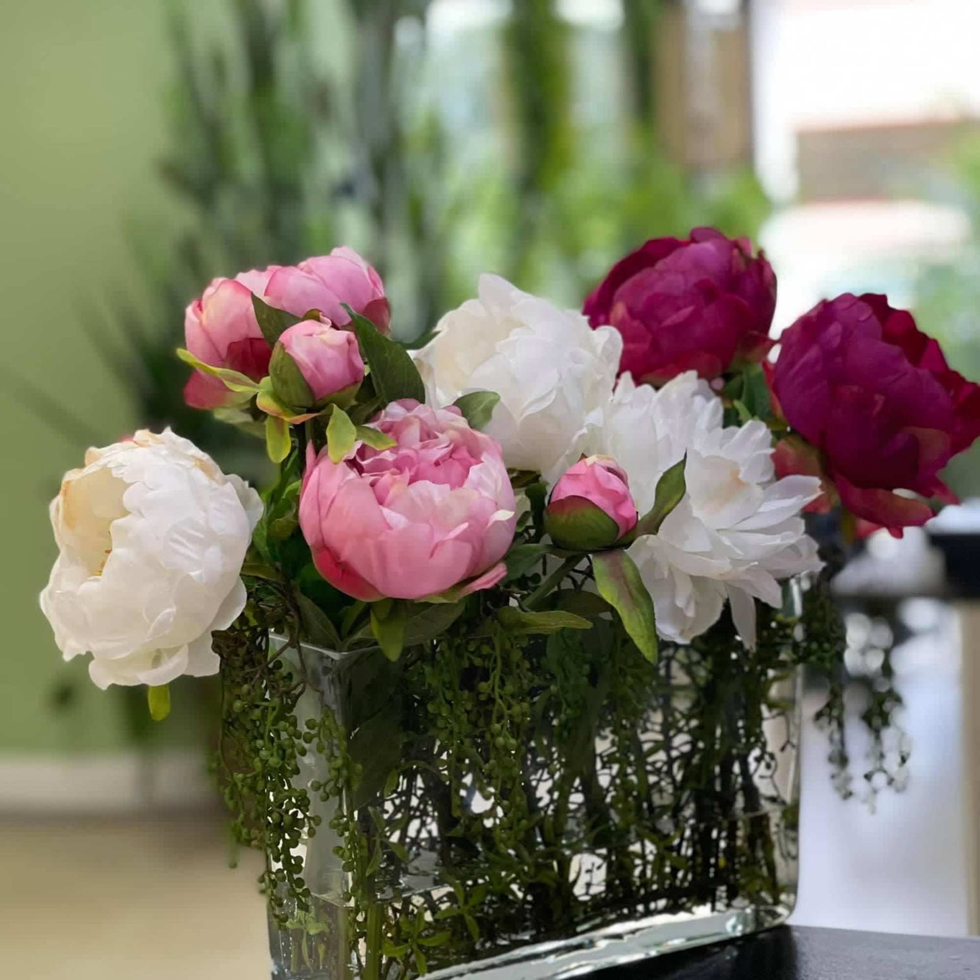 Great quality artificial peonies in a nice rectangular clear vase with water