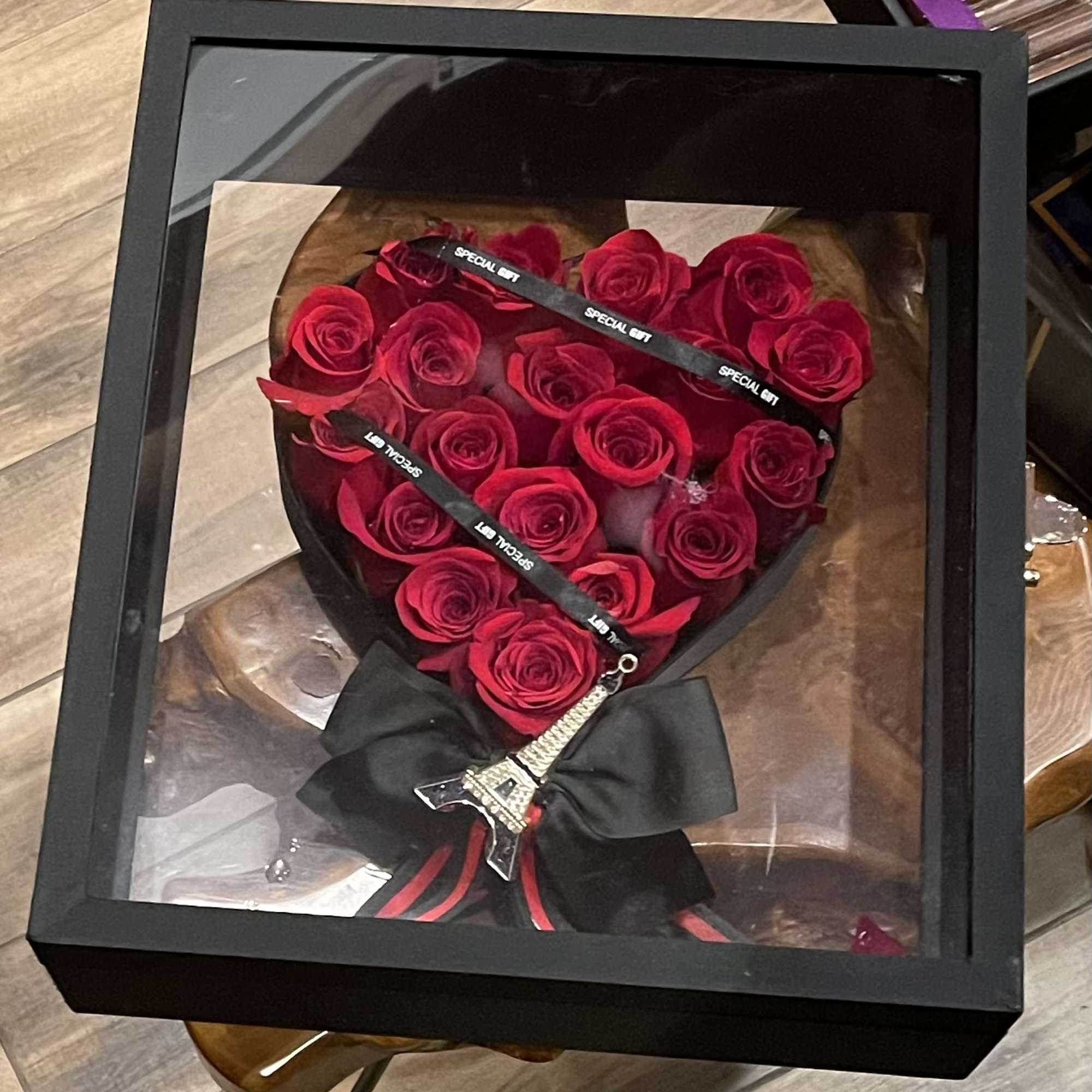 Briefcase with heart full of red roses inside