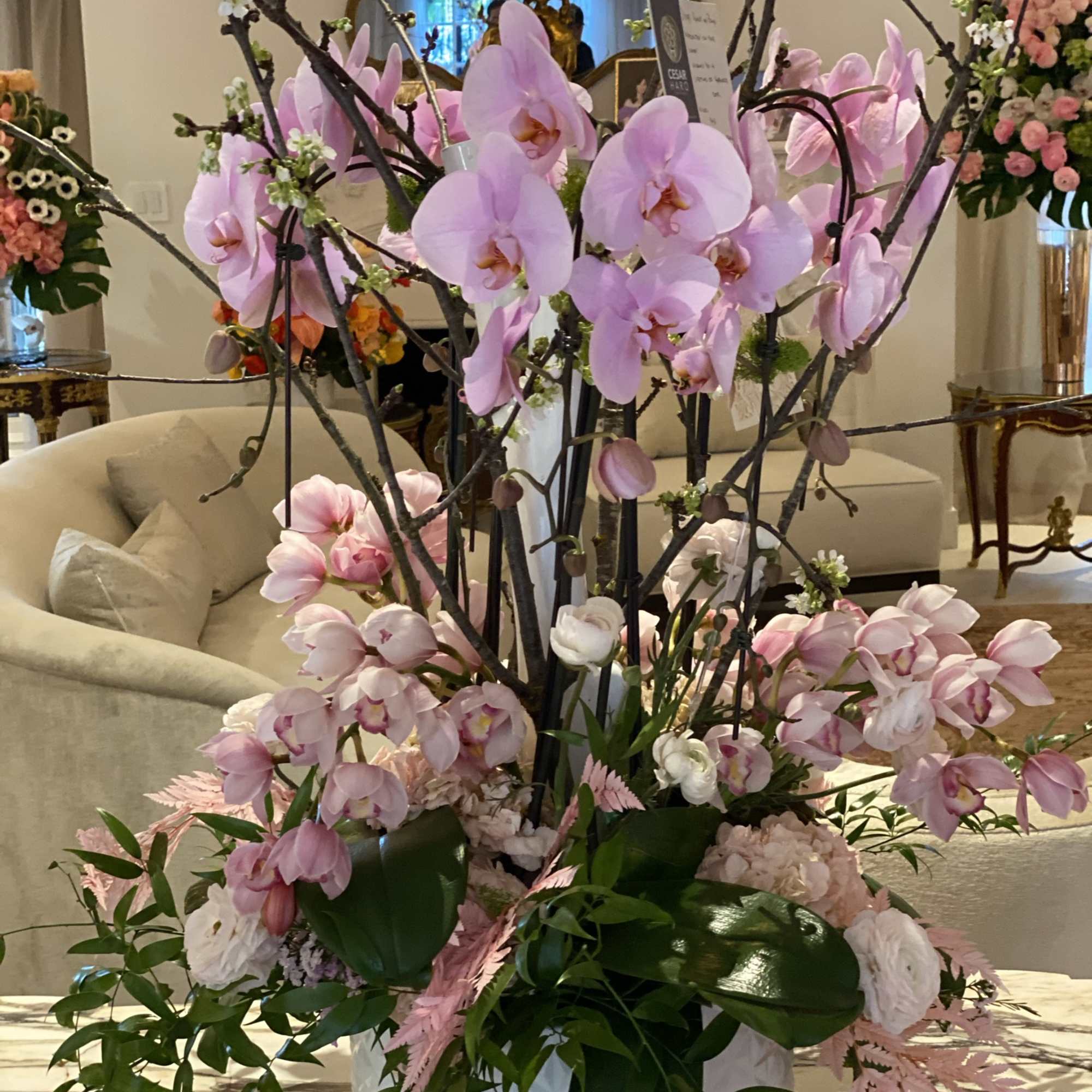 Unique ceramic white vase with orchids, fresh flowers and lots of charm