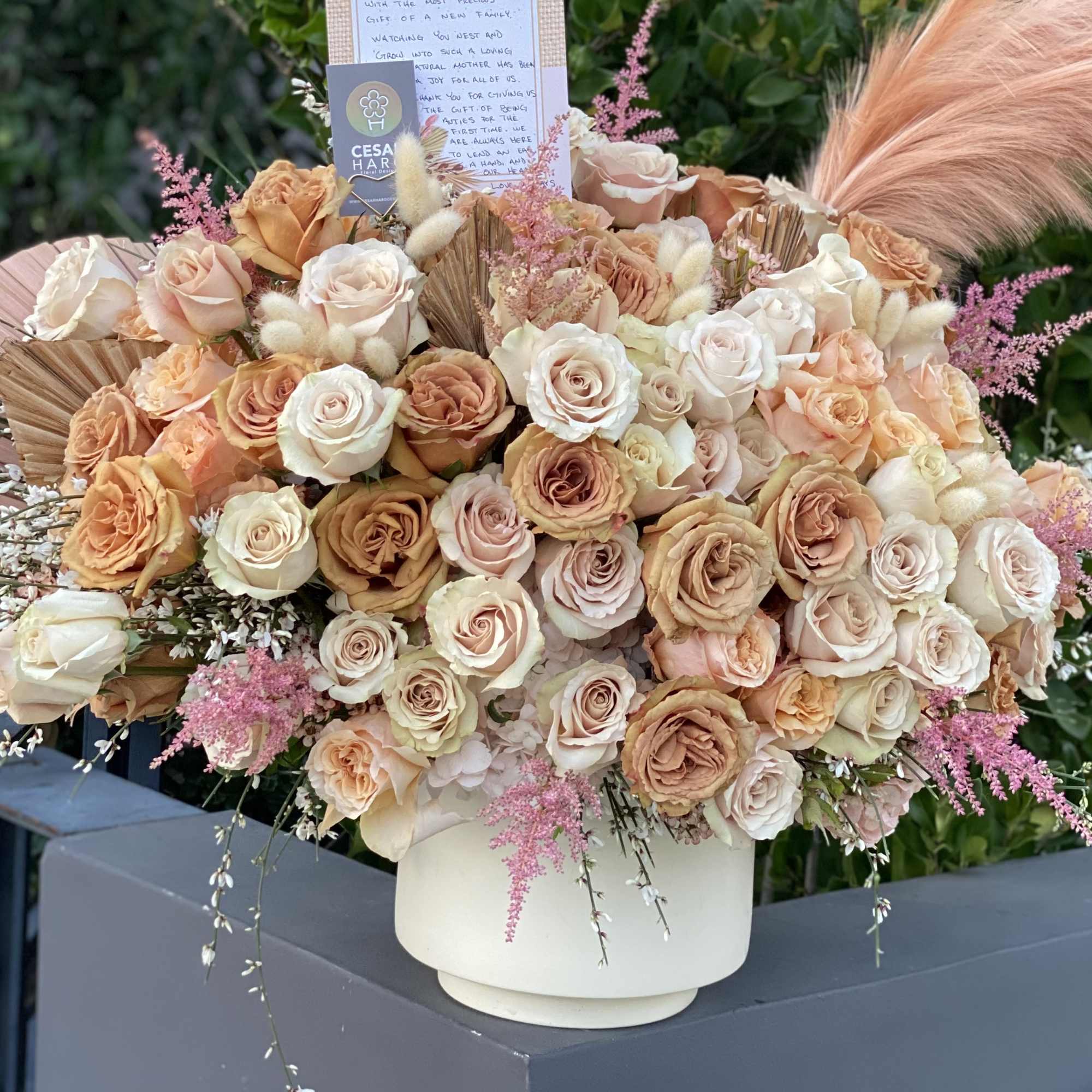 Caramel/toffee, cream &amp; blush roses with touches of pink. 