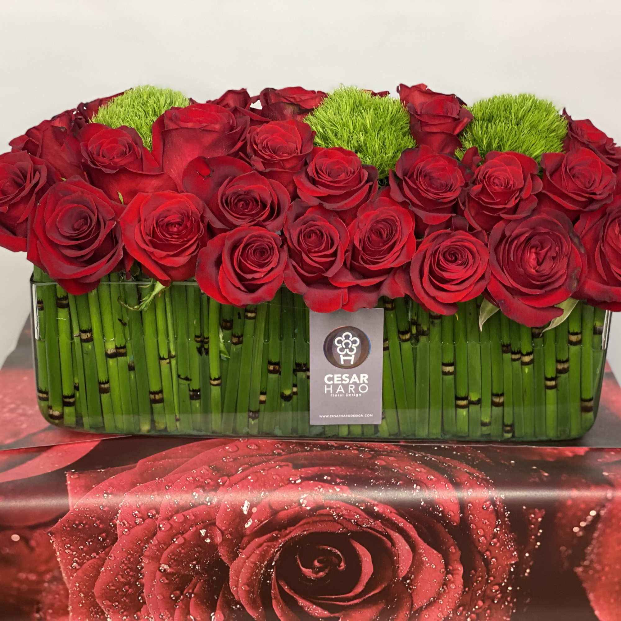 50 Ecuador big red roses  are gathered together, with green moss, photo 2 of 3