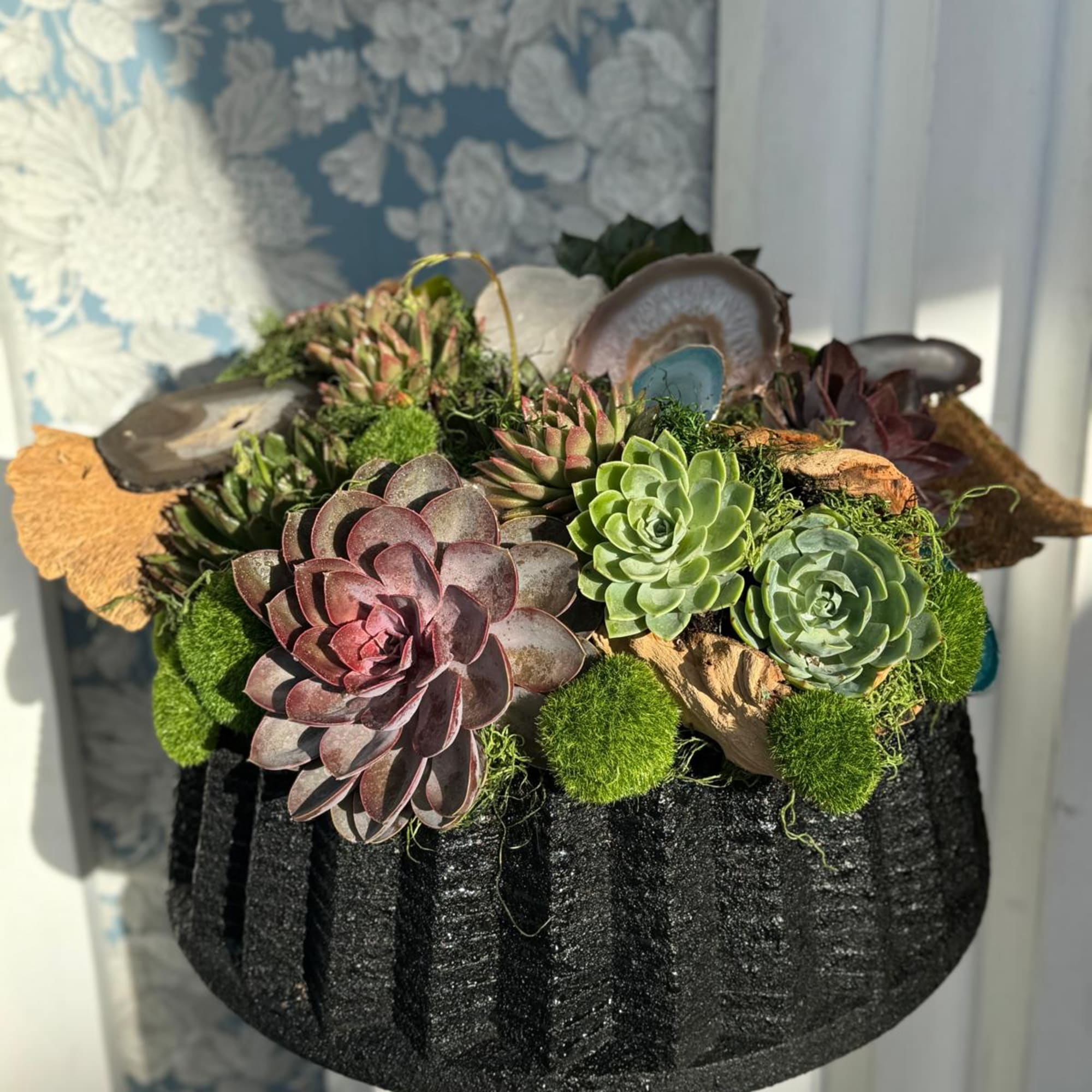 This succulent floral design is a striking, energy-enhancing arrangement featuring a selection