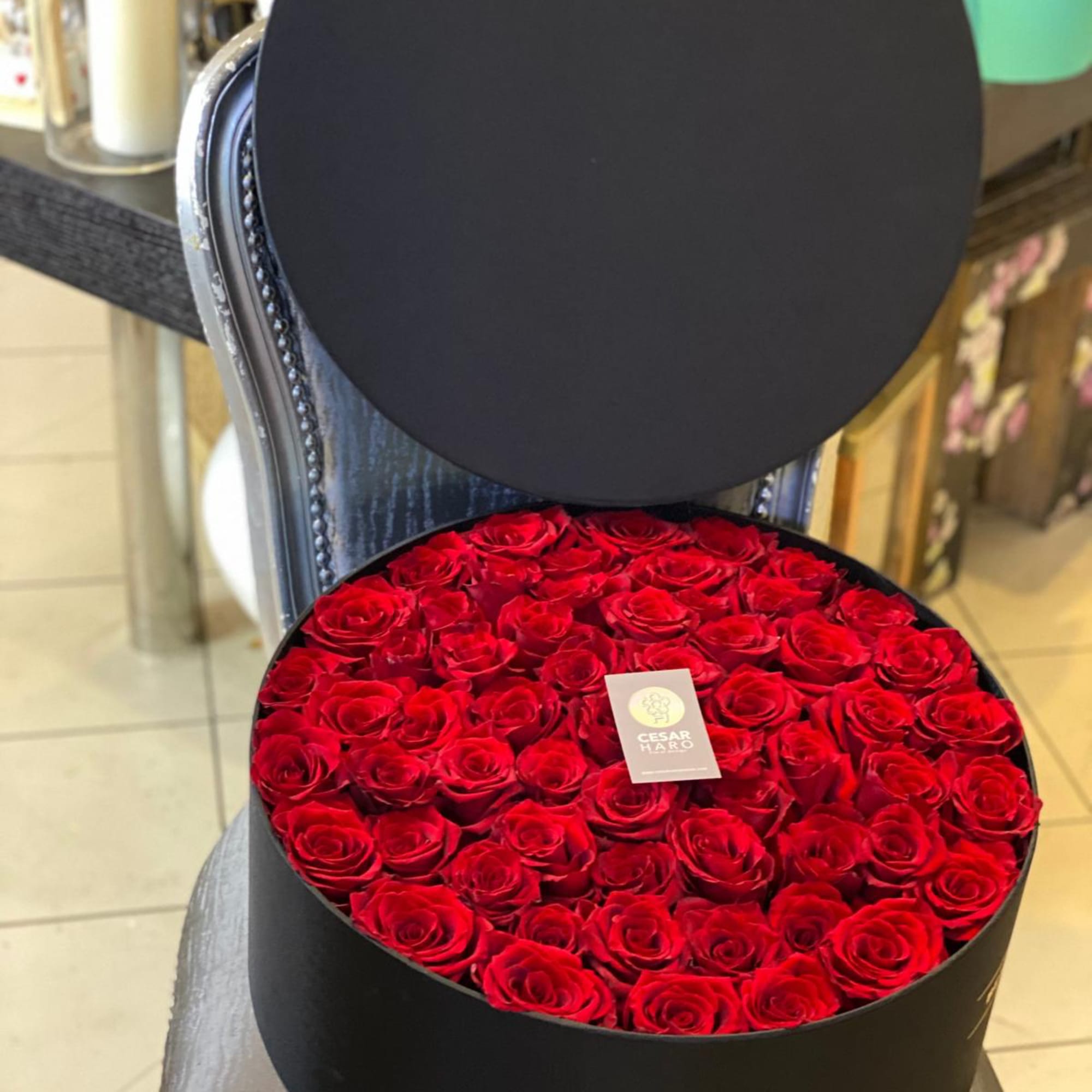 This elegant flower arrangement features stunning red roses artfully arranged in a
