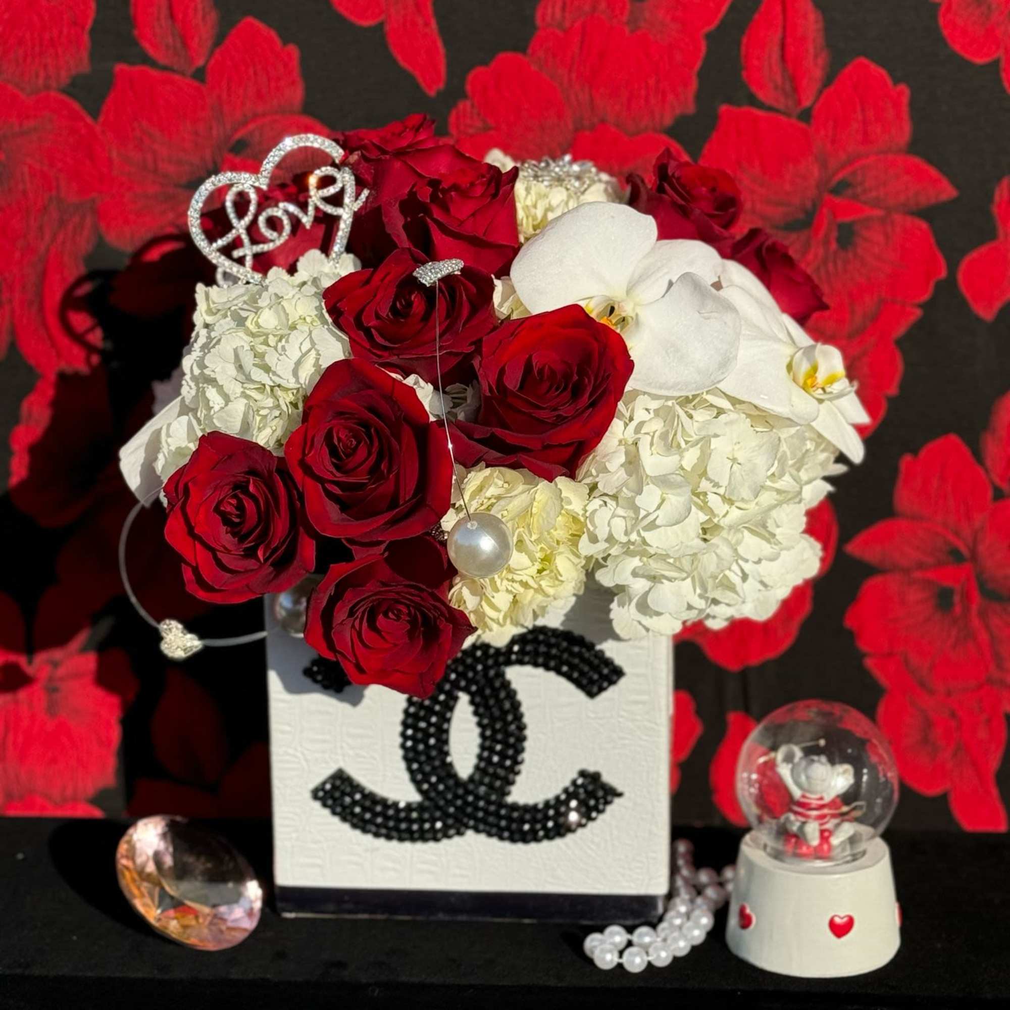 Experience the epitome of sophistication with this exquisite floral arrangement presented in