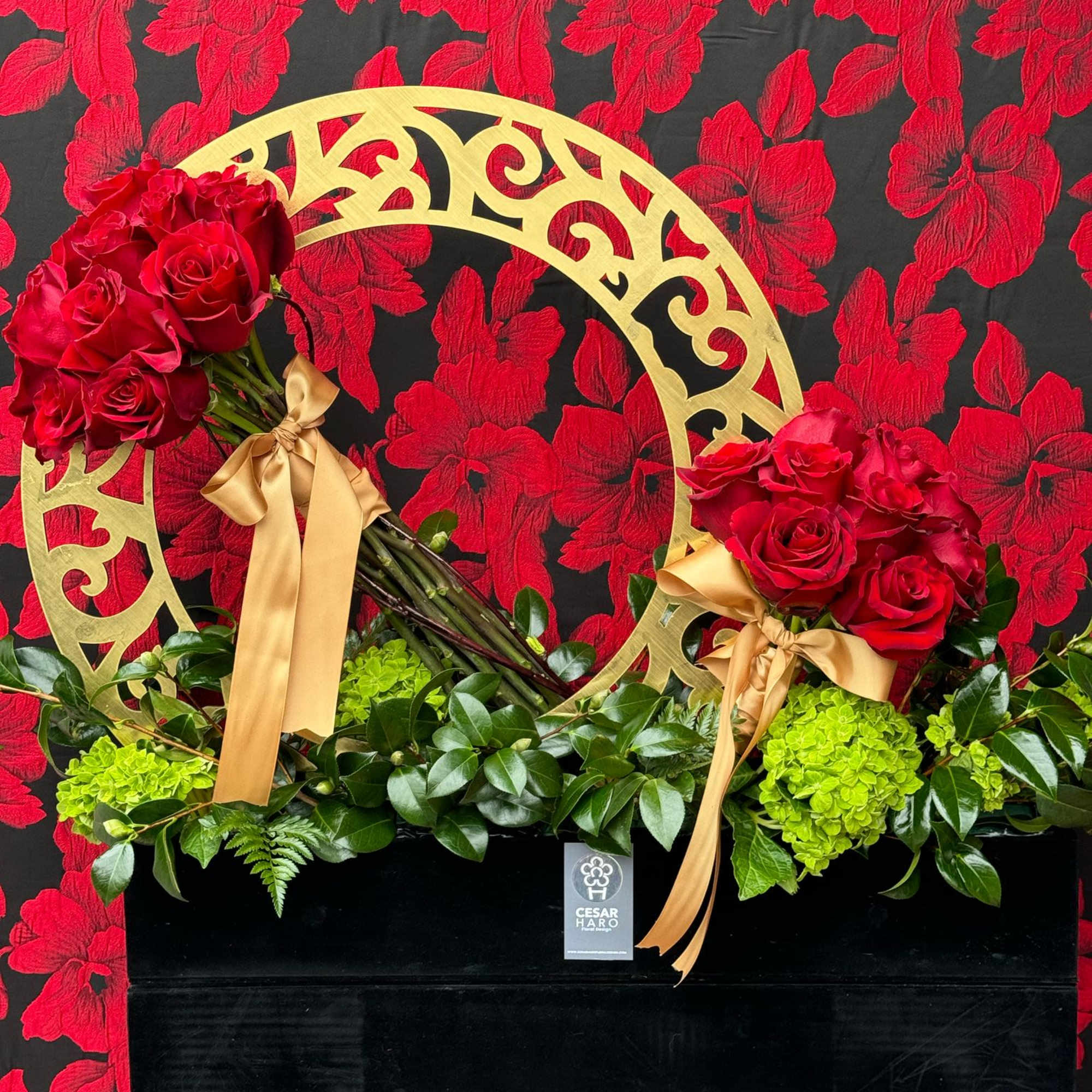 A luxurious and sophisticated arrangement of deep red roses nestled in a