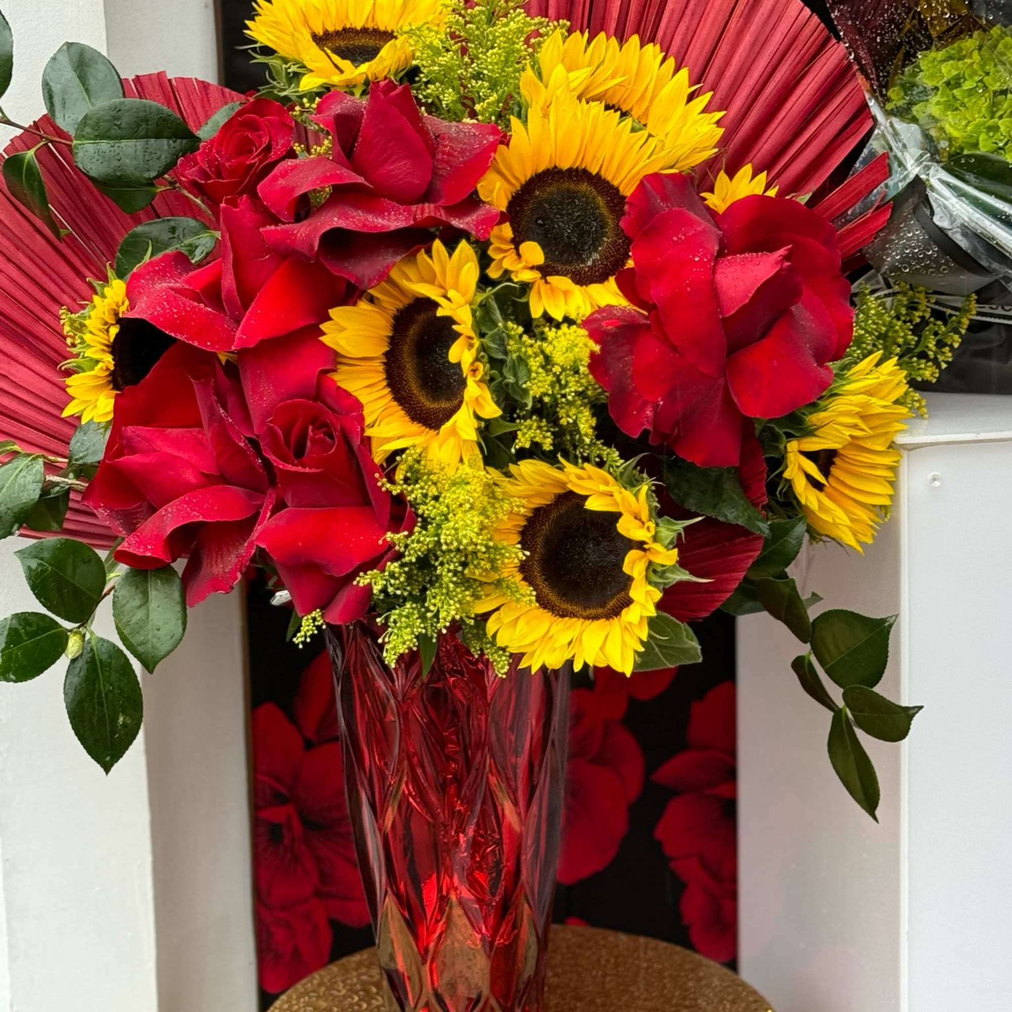 A radiant arrangement featuring bright yellow sunflowers paired with rich red roses