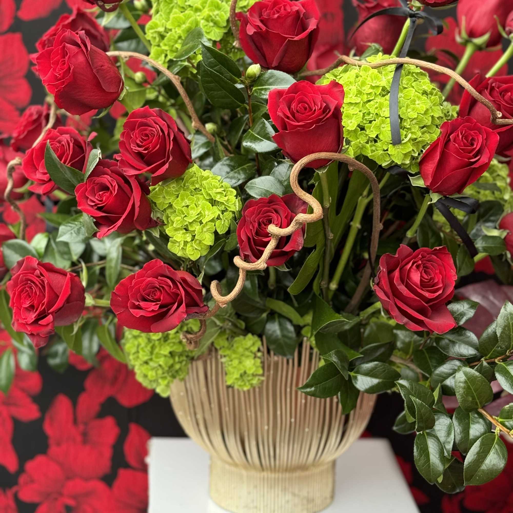 A captivating arrangement of rich red roses and soft hydrangeas, with delicate, photo 2 of 2