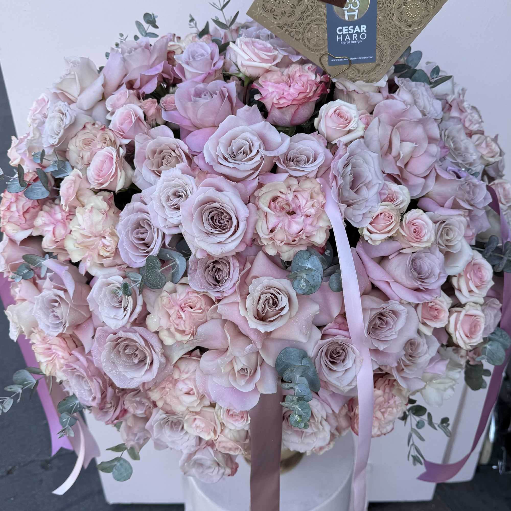 Floral arrangement filled with roses in a unique reusable wood vase. , photo 2 of 2