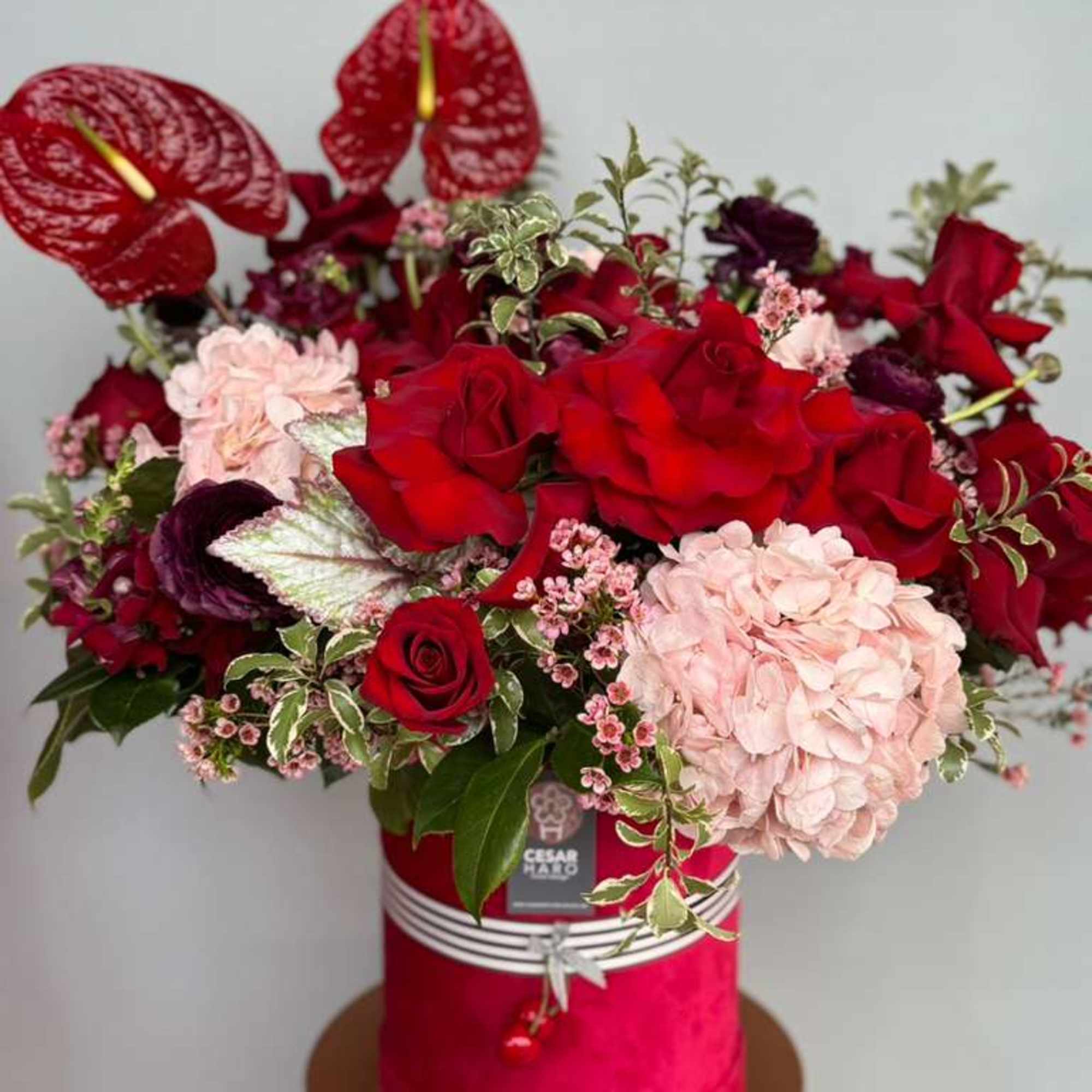 Sweep your sweetheart off their feet. Red roses, hydrangeas, anthuriums, and other