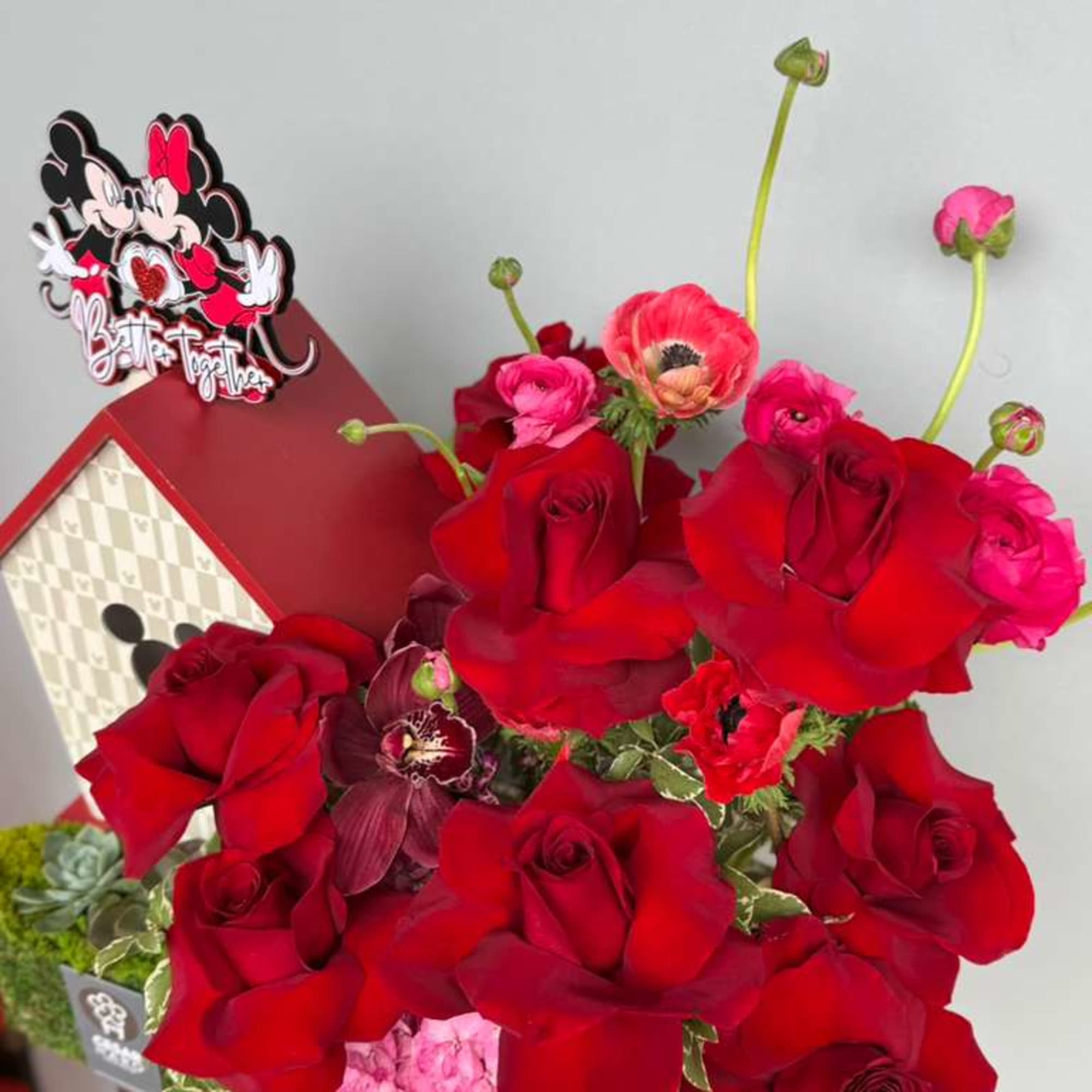 Romantic red roses paired with delicate ranunculus and bold anemones, beautifully styled, photo 2 of 2