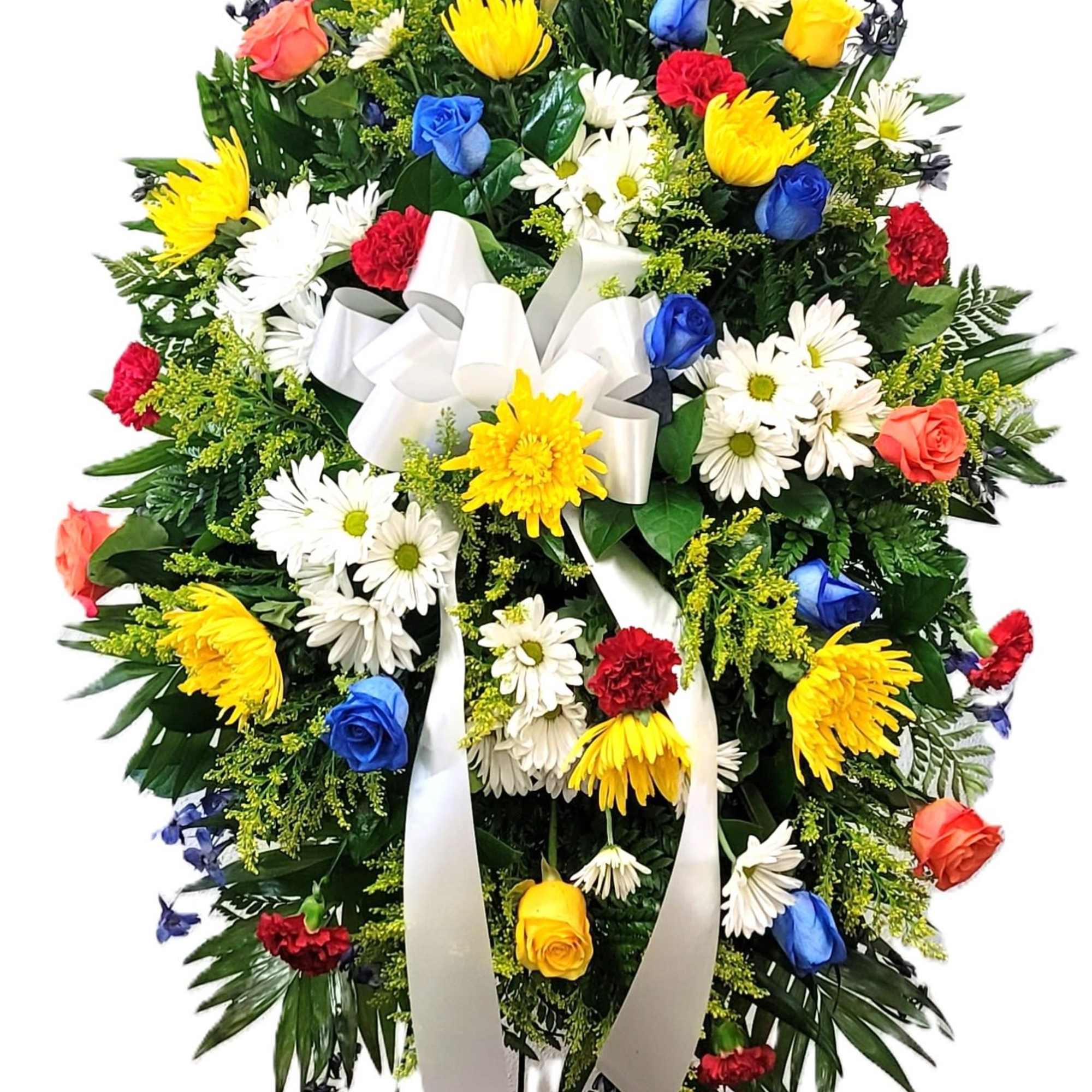 Standing funeral spray with mixed roses and daisies on a white ribbon
