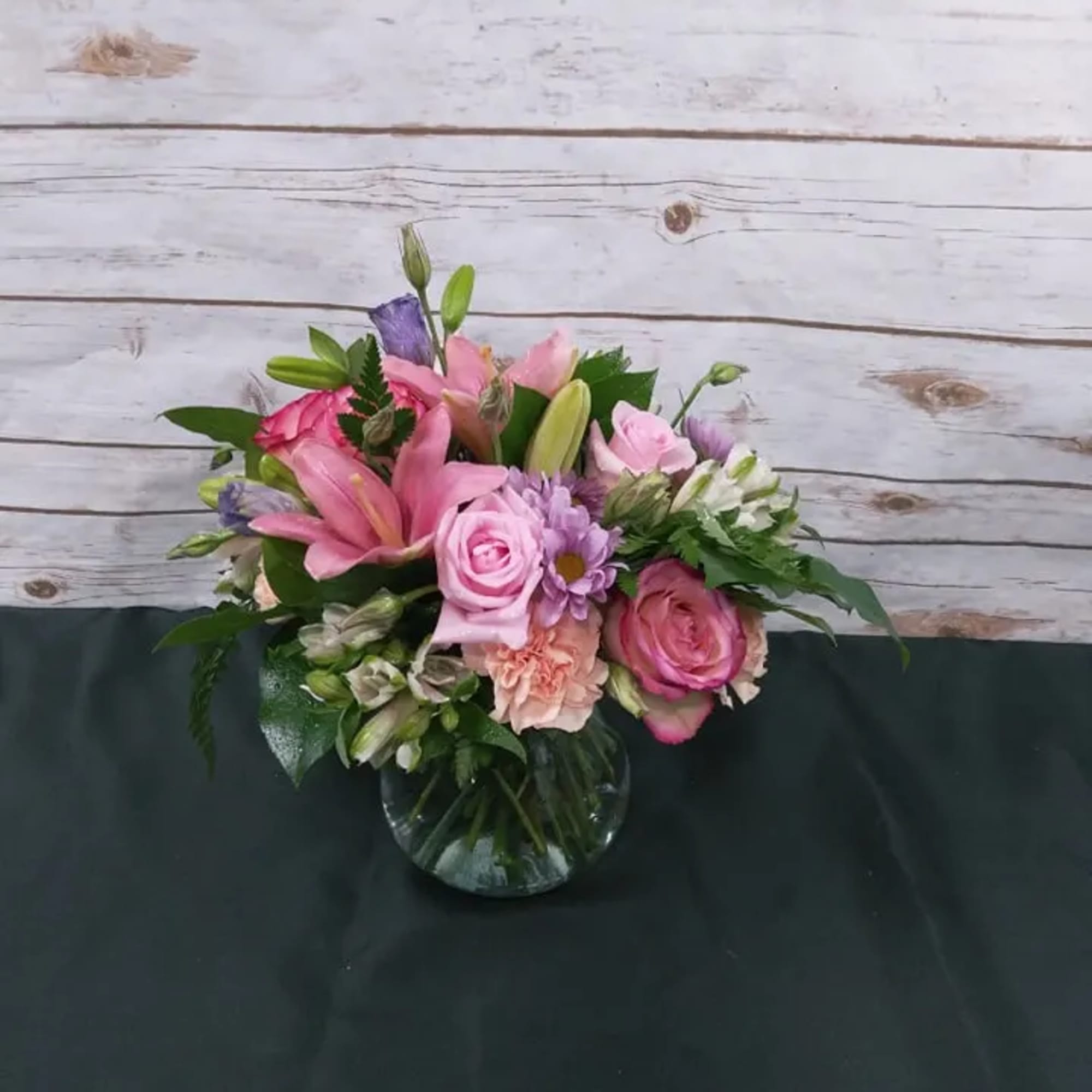 Pink and purple mixed bouquet in a glass vase