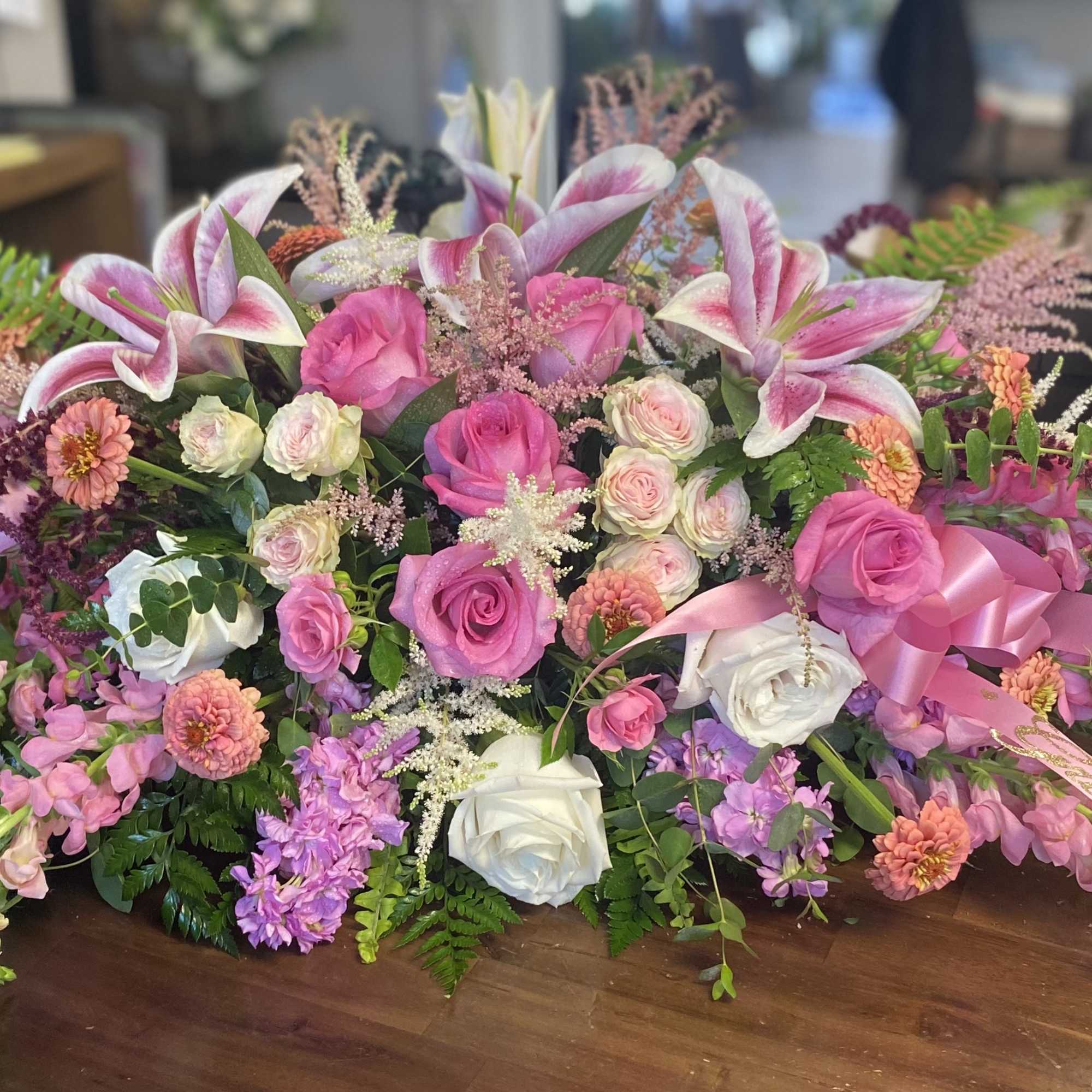 Large pink and white floral arrangement with roses and lilies