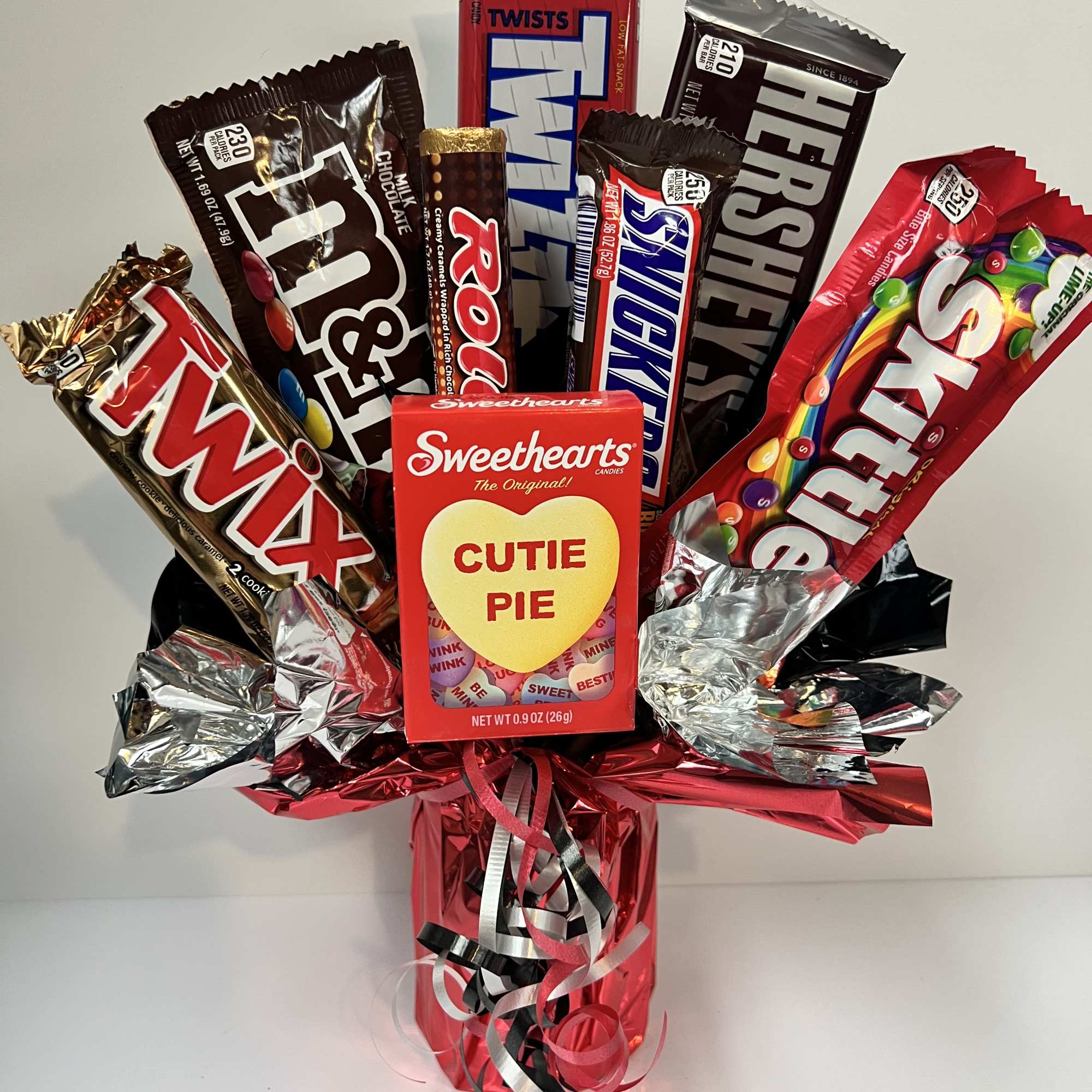 Candy bouquet with assorted chocolate bars and Sweethearts in red wrap