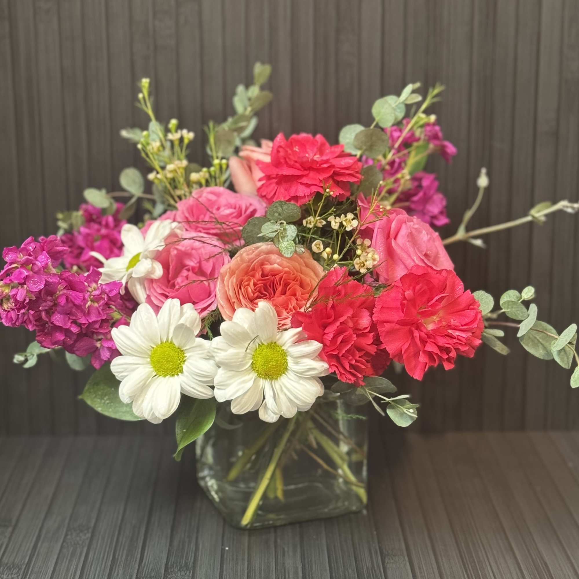 Pink and white mixed bouquet in a square glass vase