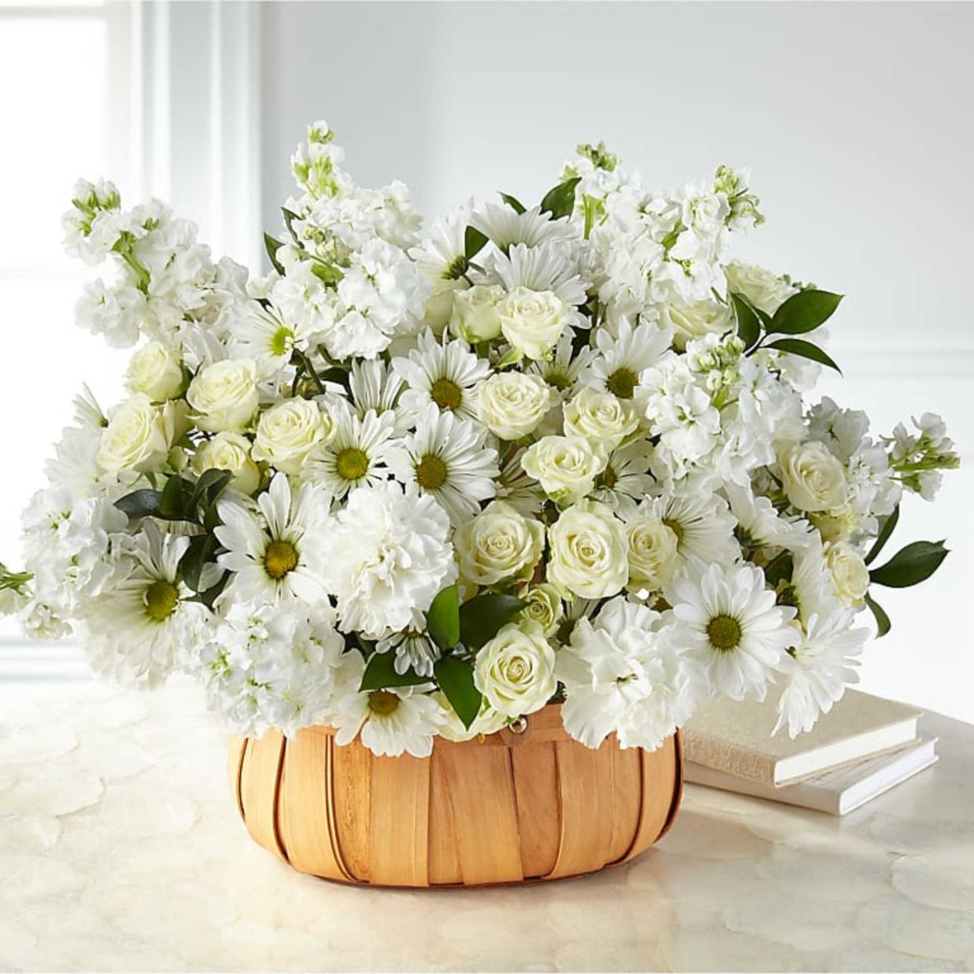 White roses and daisies in a wooden basket