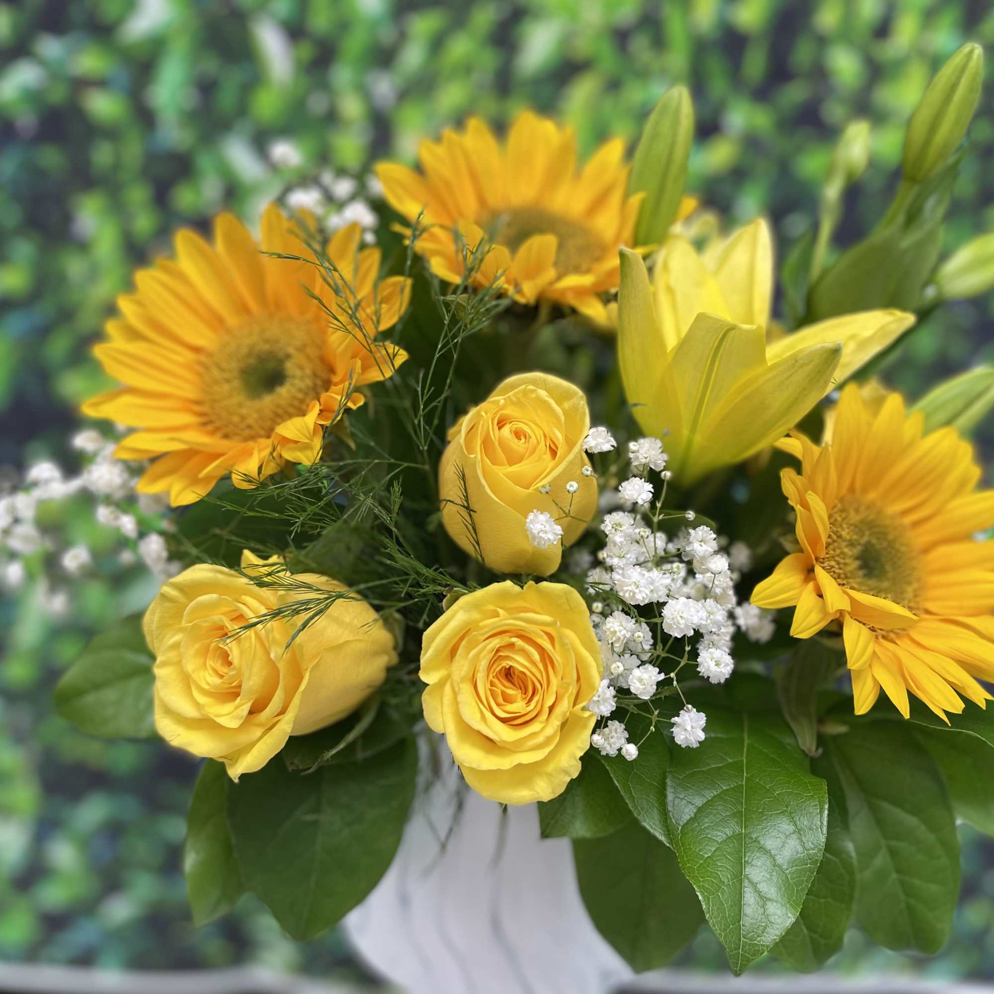 A stunning white marble keepsake vase with fresh greenery yellow roses sunflowers, photo 2 of 2