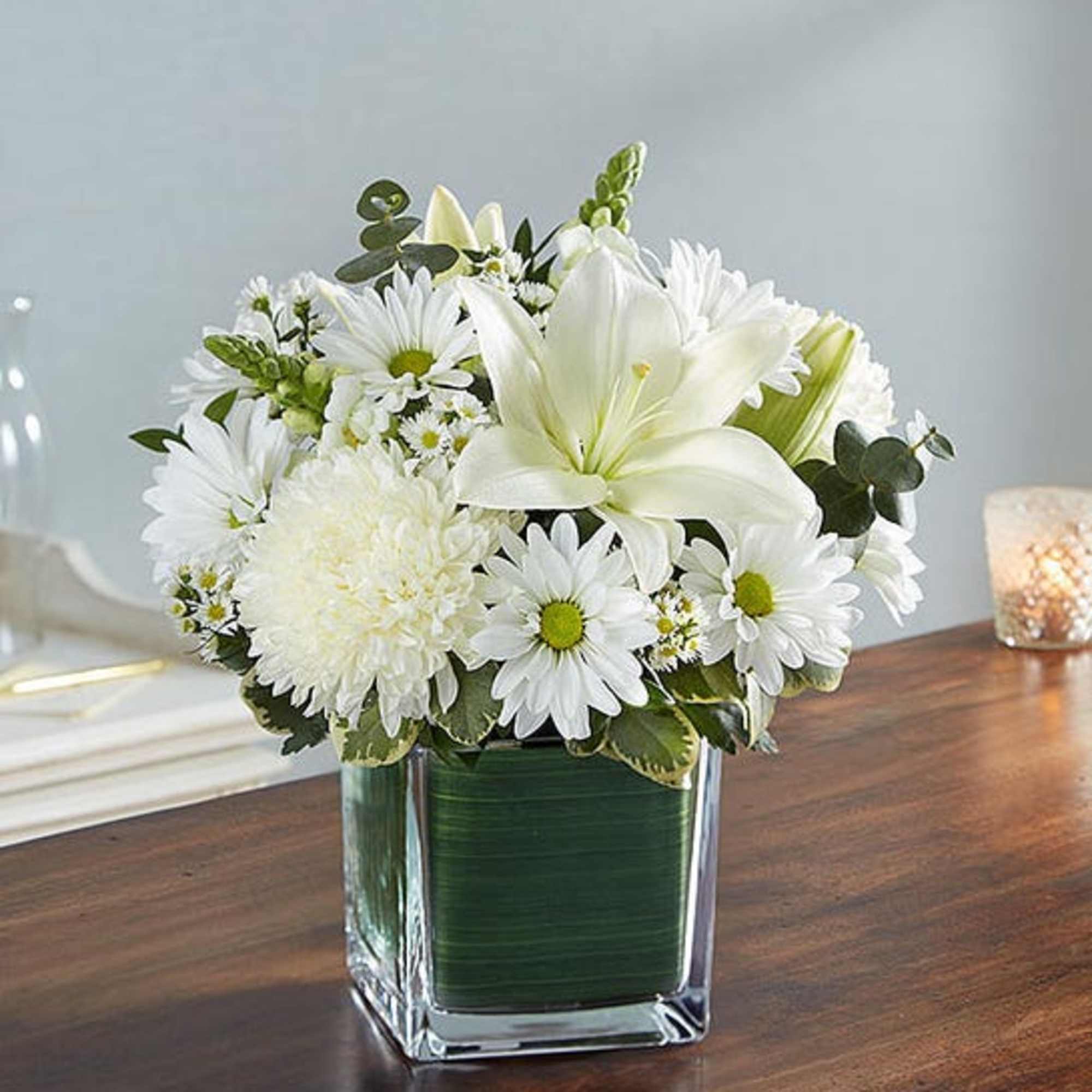 Elegant white flowers help to convey your deepest sympathies with graceful beauty