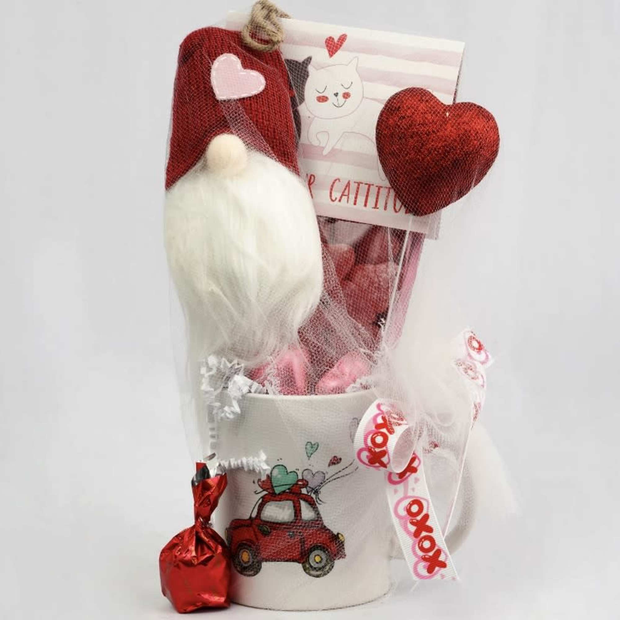 Gift mug with a gnome decoration, heart accents, and a small wrapped candy
