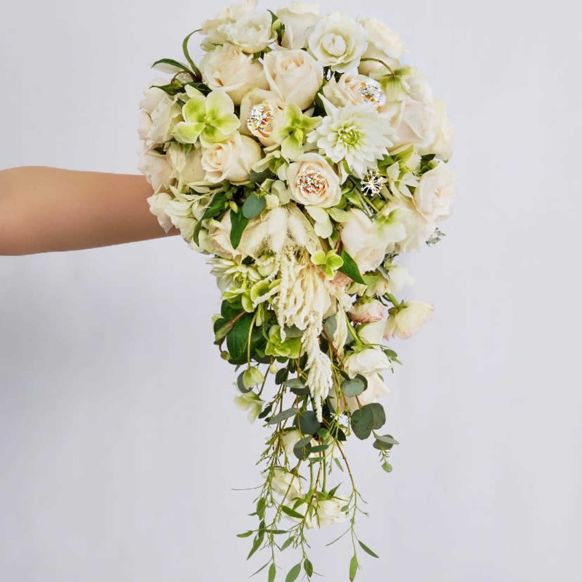 Trailing bouquet of white and pale green flowers with cascading greenery