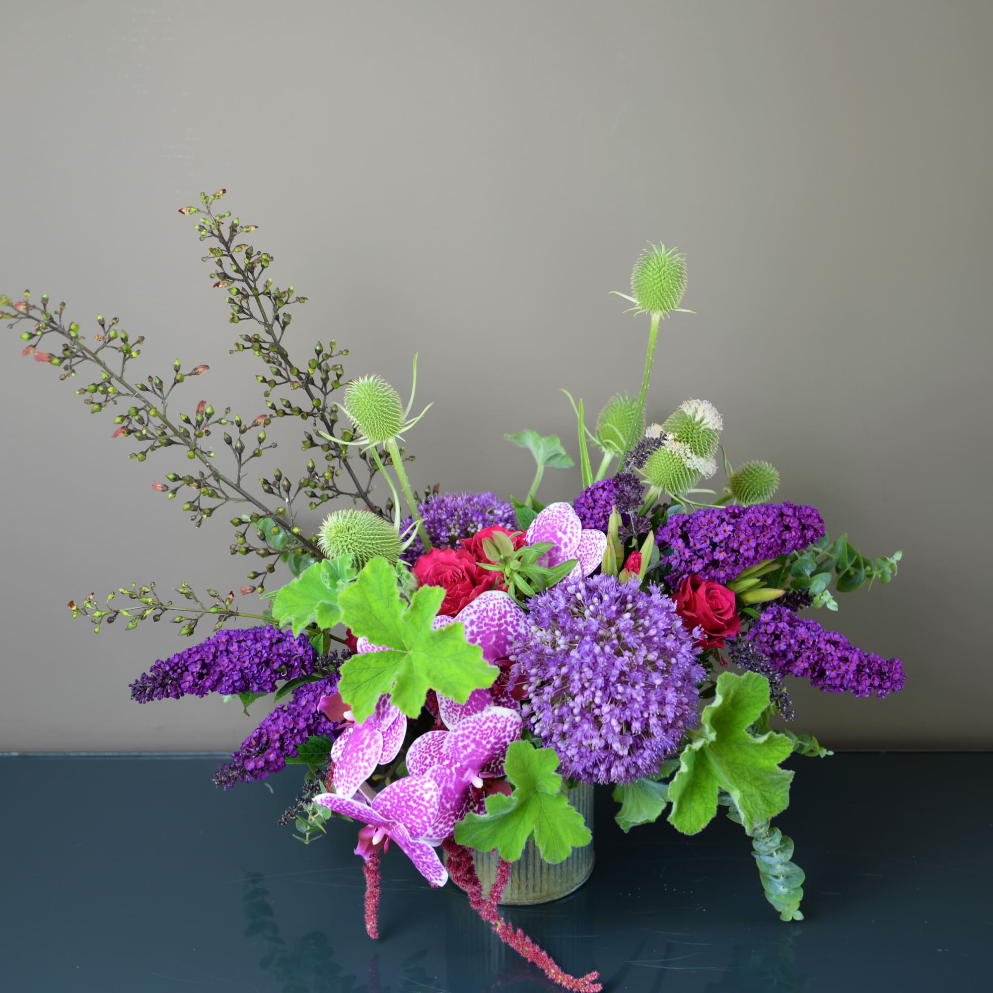 Purple and pink floral arrangement in a glass vase