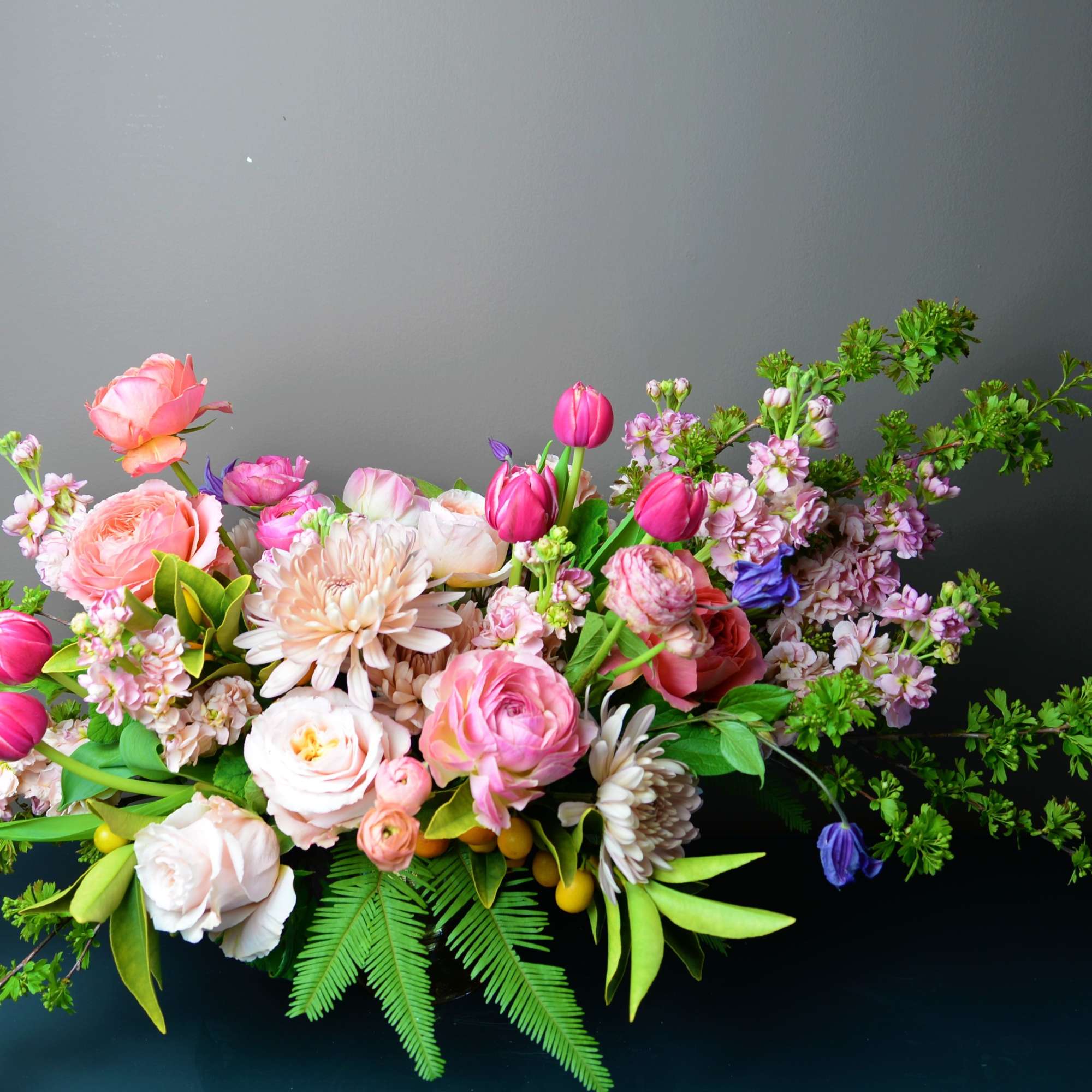 Pink and white mixed flower arrangement with tulips and roses
