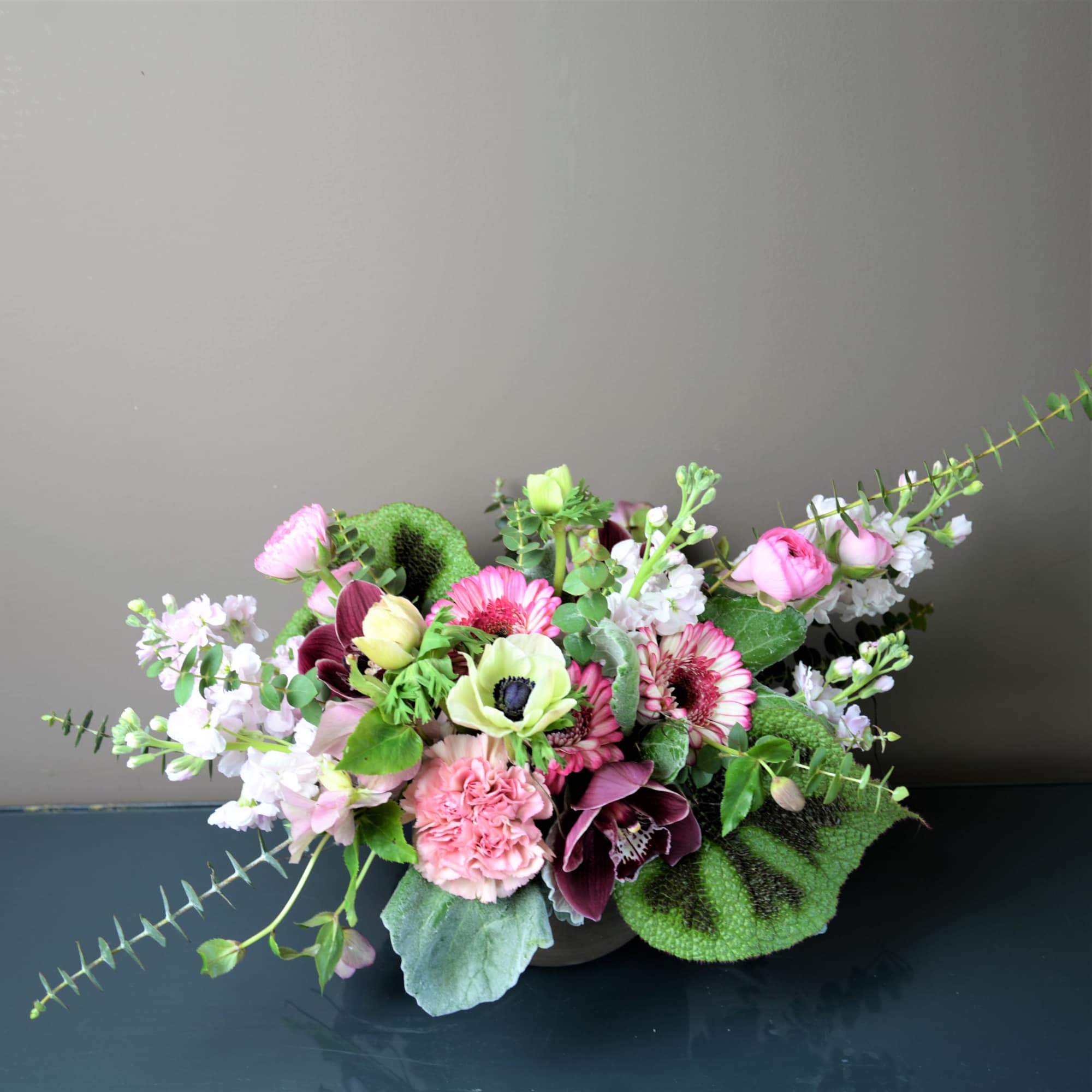 Mixed pink and white floral arrangement in a low vase