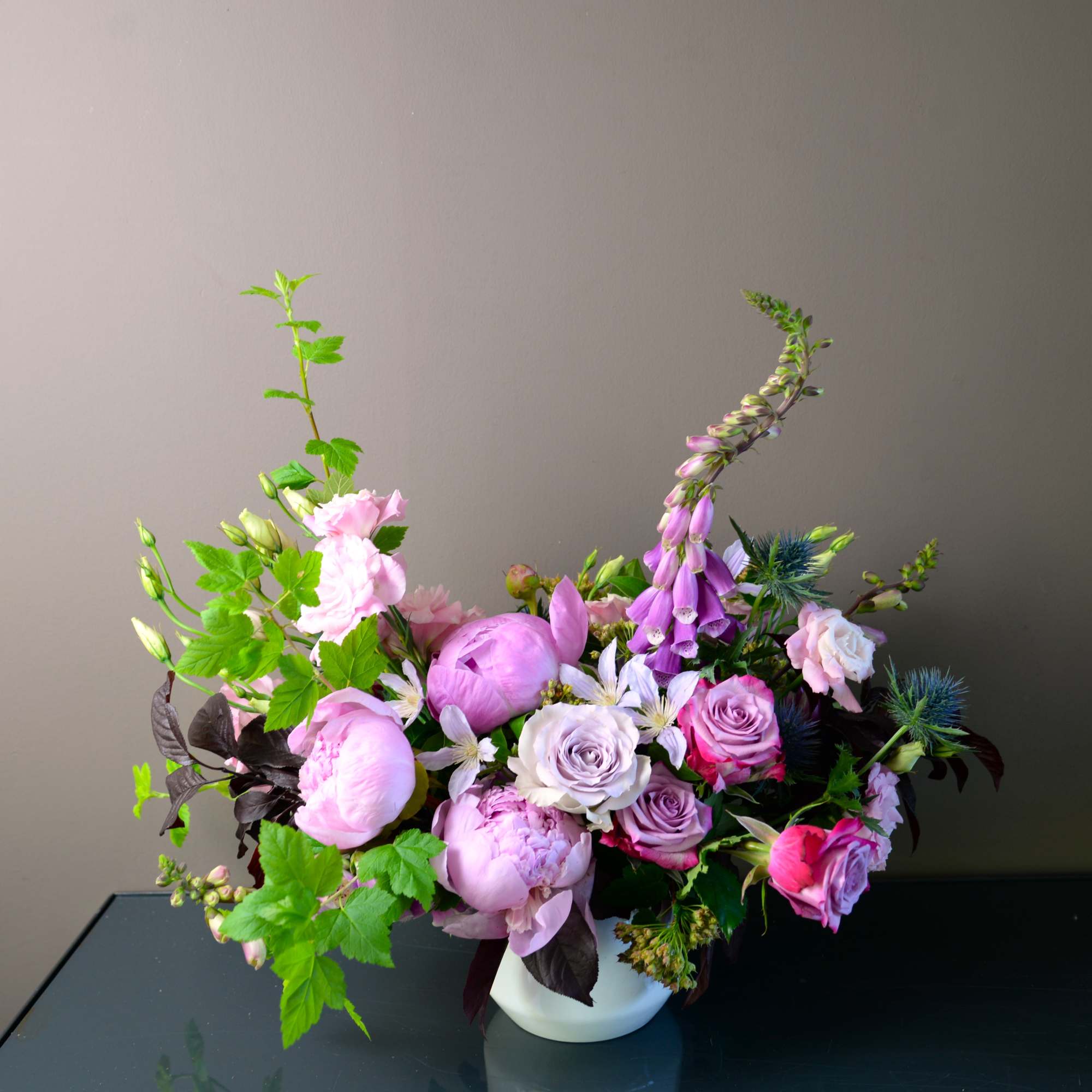 Pink and lavender floral arrangement in a white vase