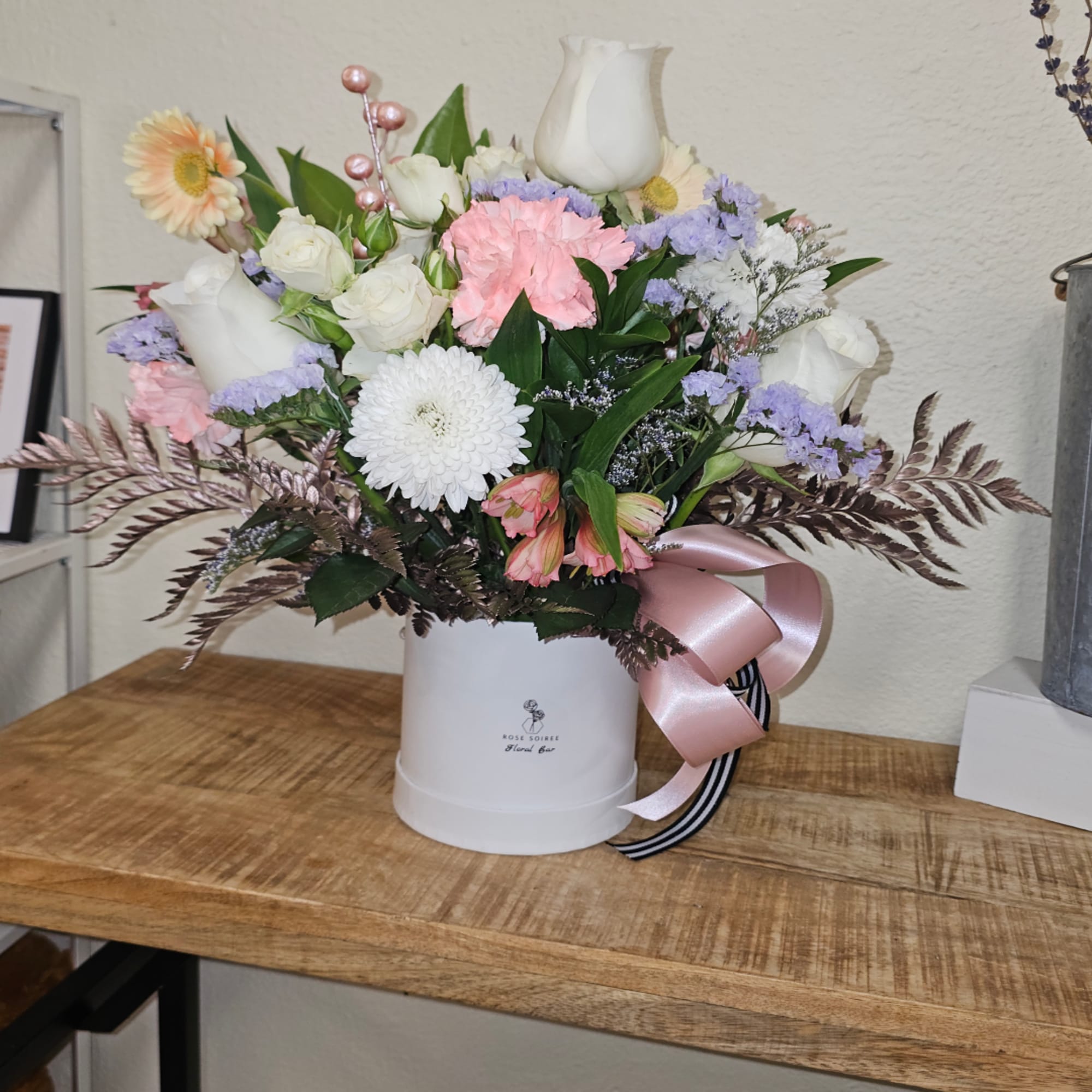 Mixed pastel bouquet in a white hatbox with a pink ribbon