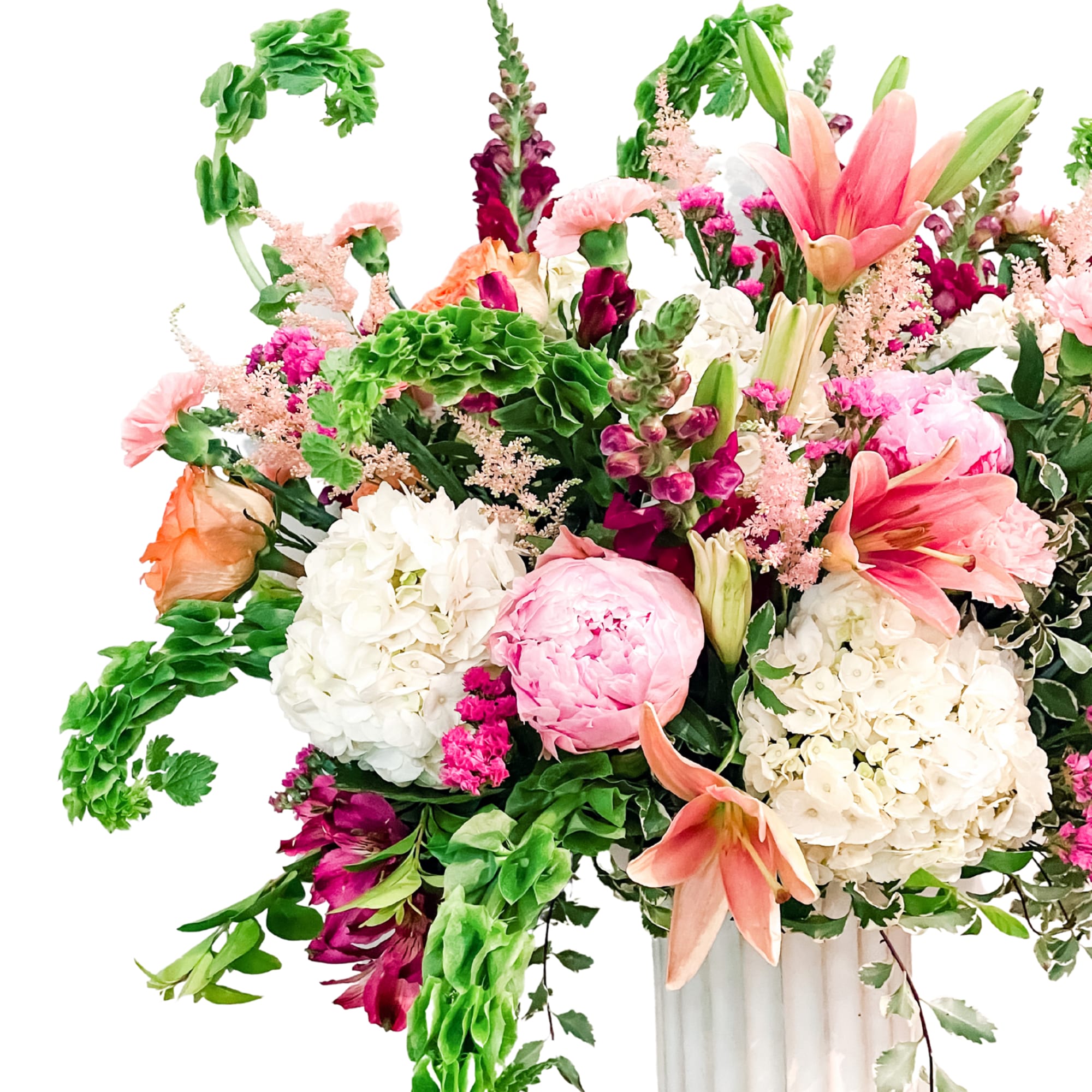 Large mixed bouquet in a white vase with pink lilies and hydrangeas