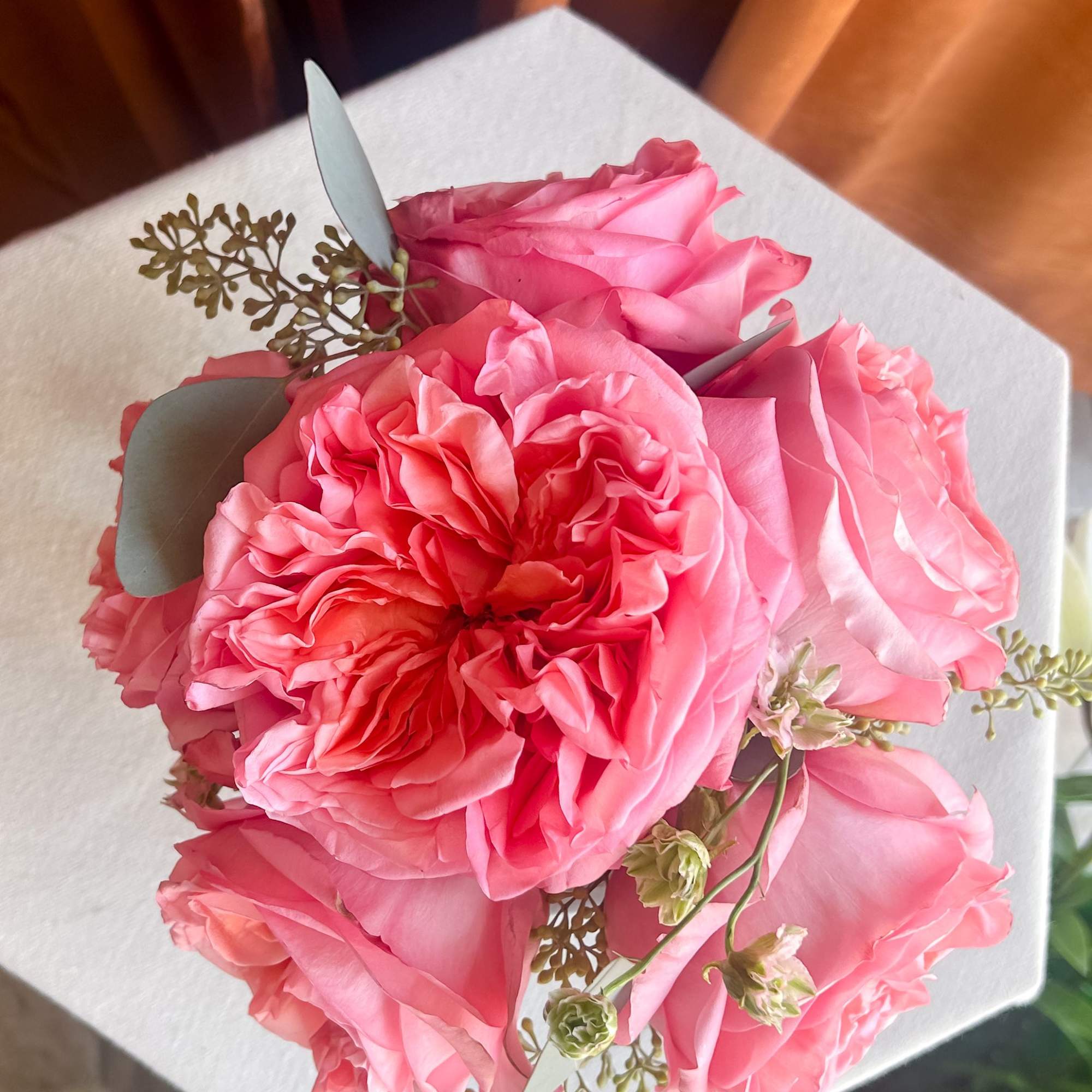 Pink rose bouquet with eucalyptus on white wrapping