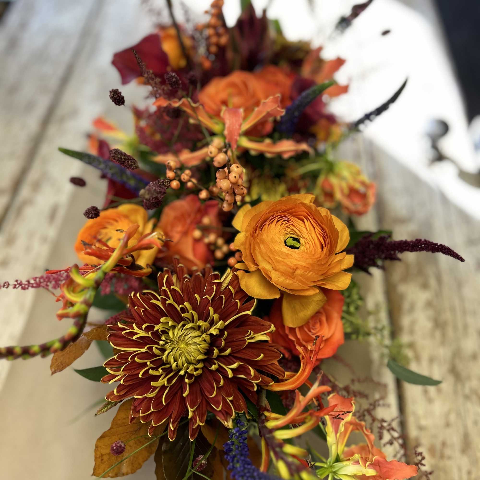 Orange and burgundy mixed bouquet with chrysanthemums and ranunculus