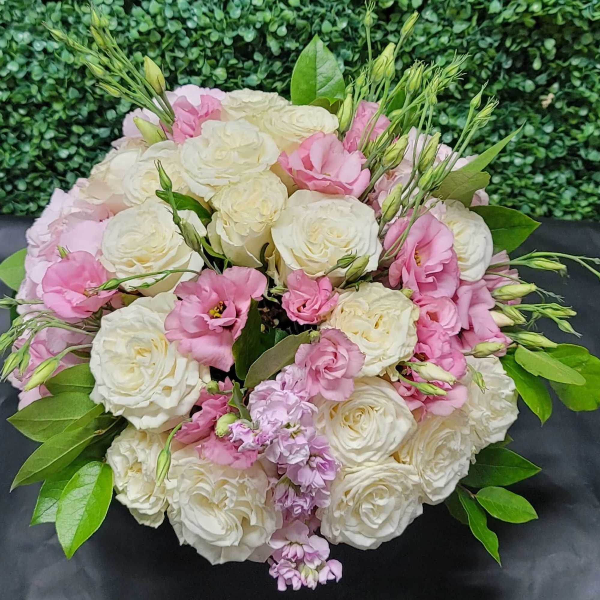 Pink and white rose bouquet with green foliage