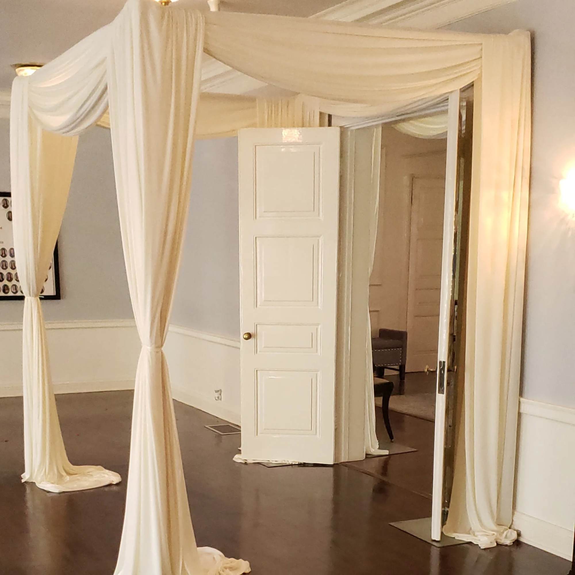 Cream draped fabric canopy in a room with mirrored panels