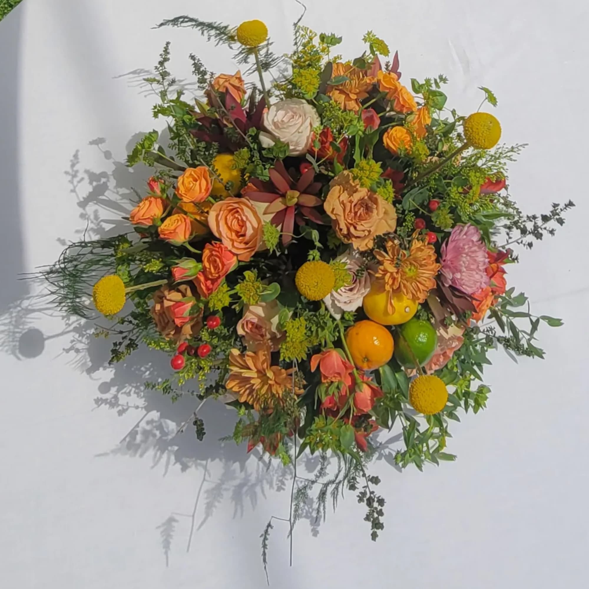Mixed bouquet with orange roses and yellow pom-pom flowers