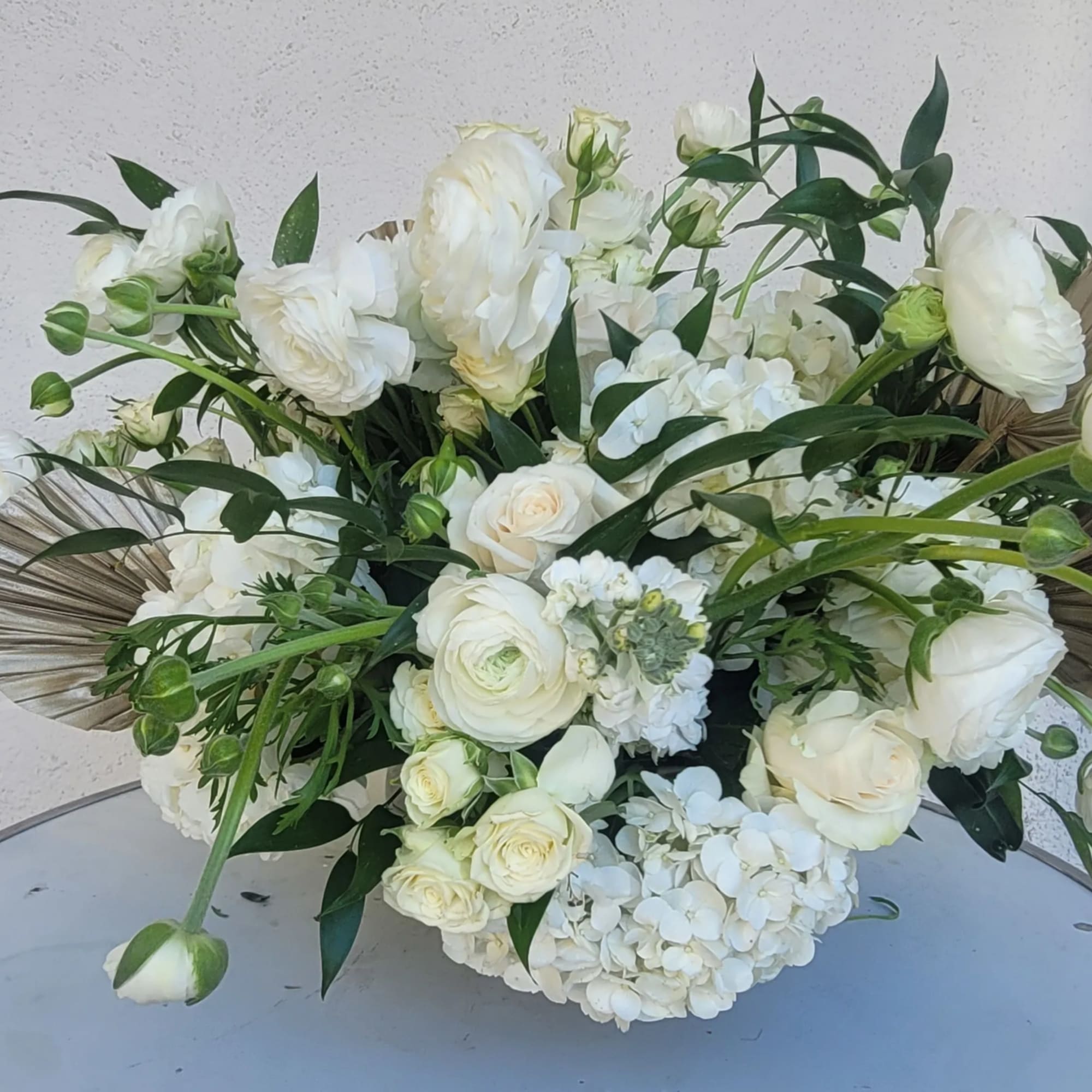 White floral bouquet with roses and ranunculus