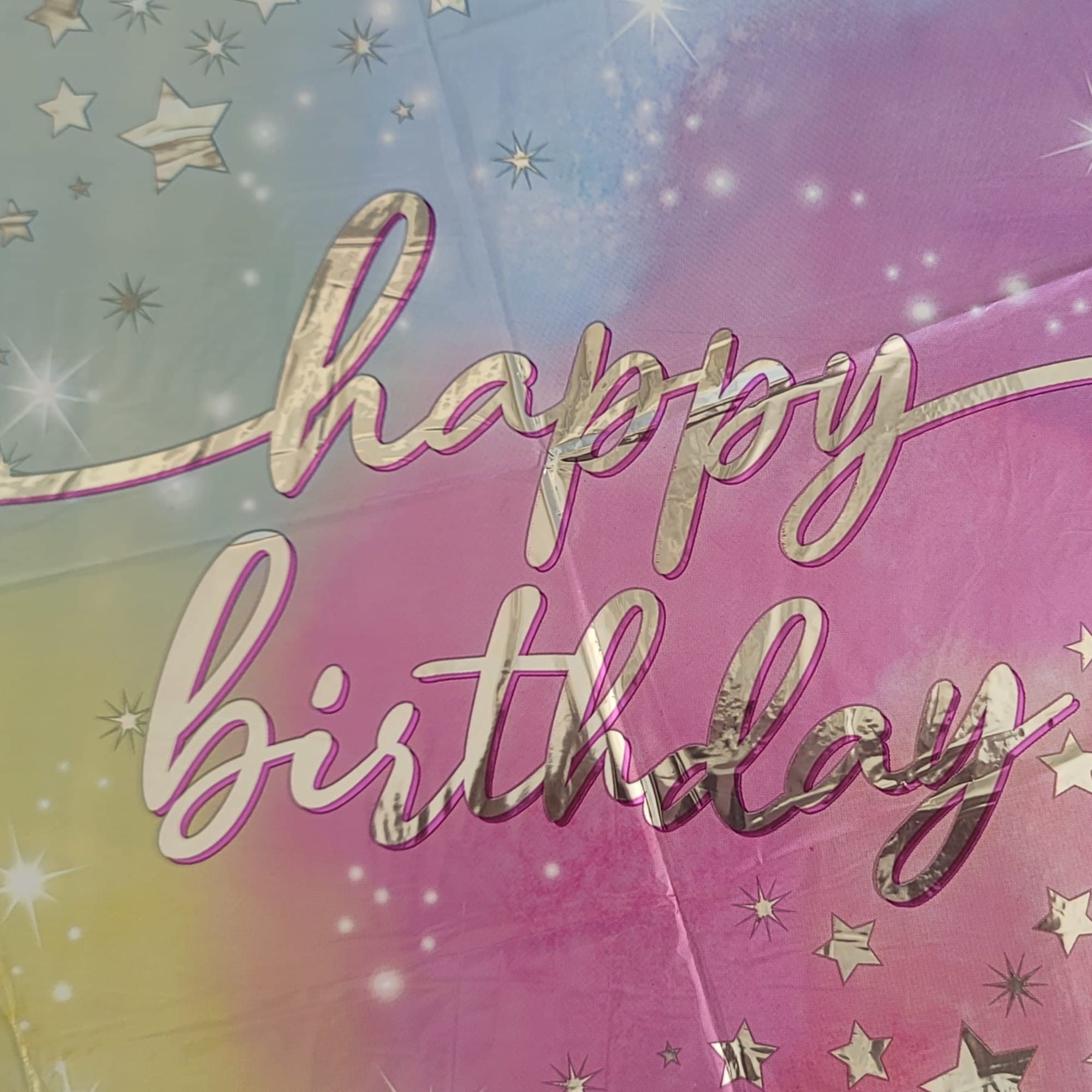 Pastel birthday balloon with stars and the words happy birthday