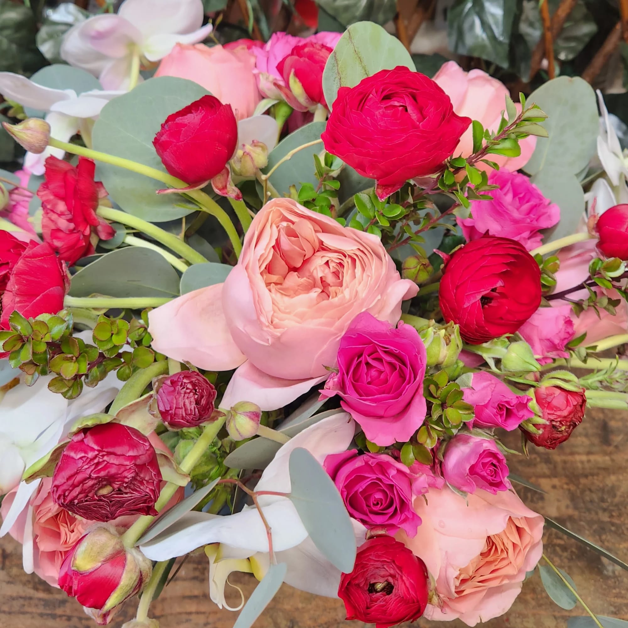 Bouquet of pink and red roses with pale eucalyptus leaves