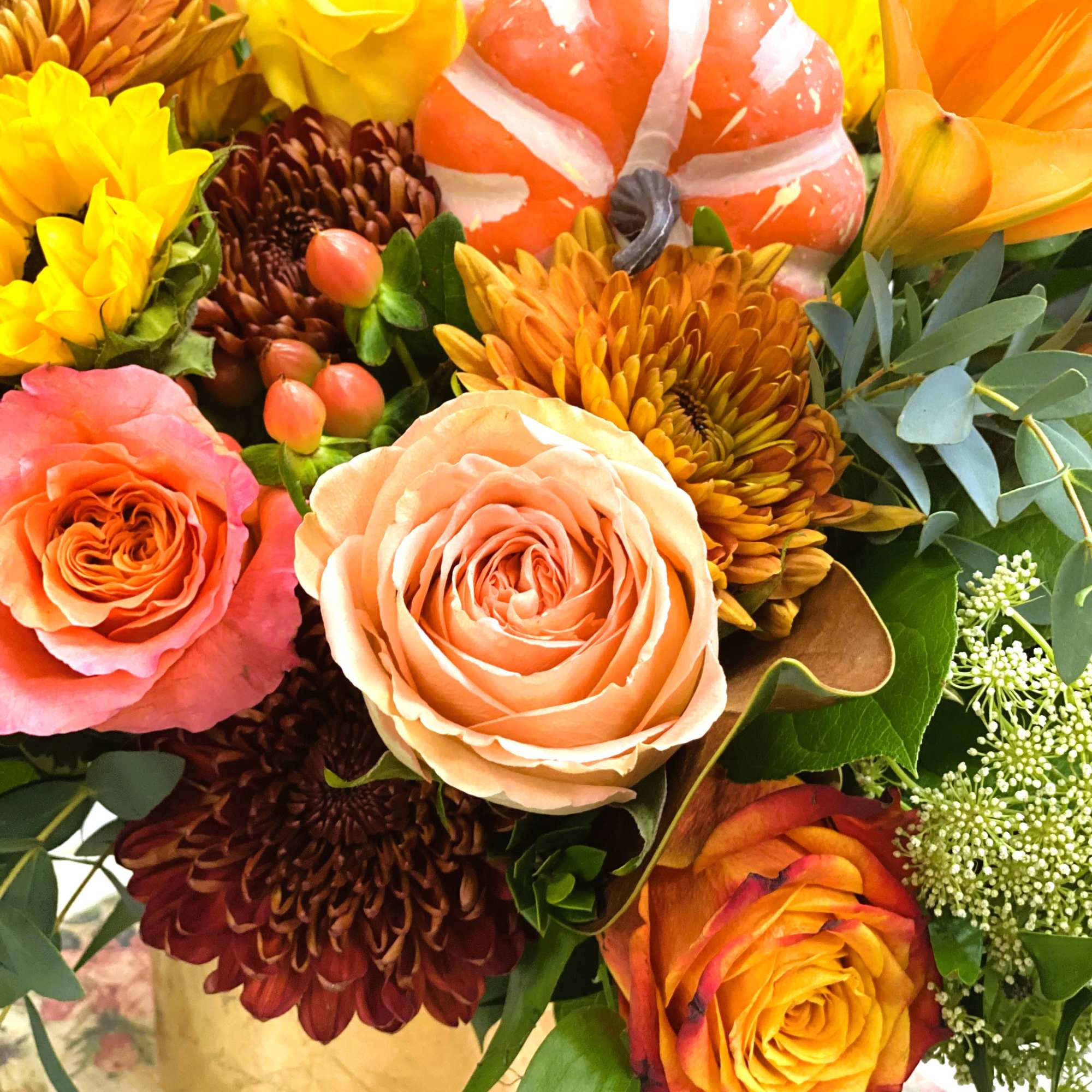 Beautiful golden cylinder filled uniquely with warm fall flowers and topped with, photo 2 of 2