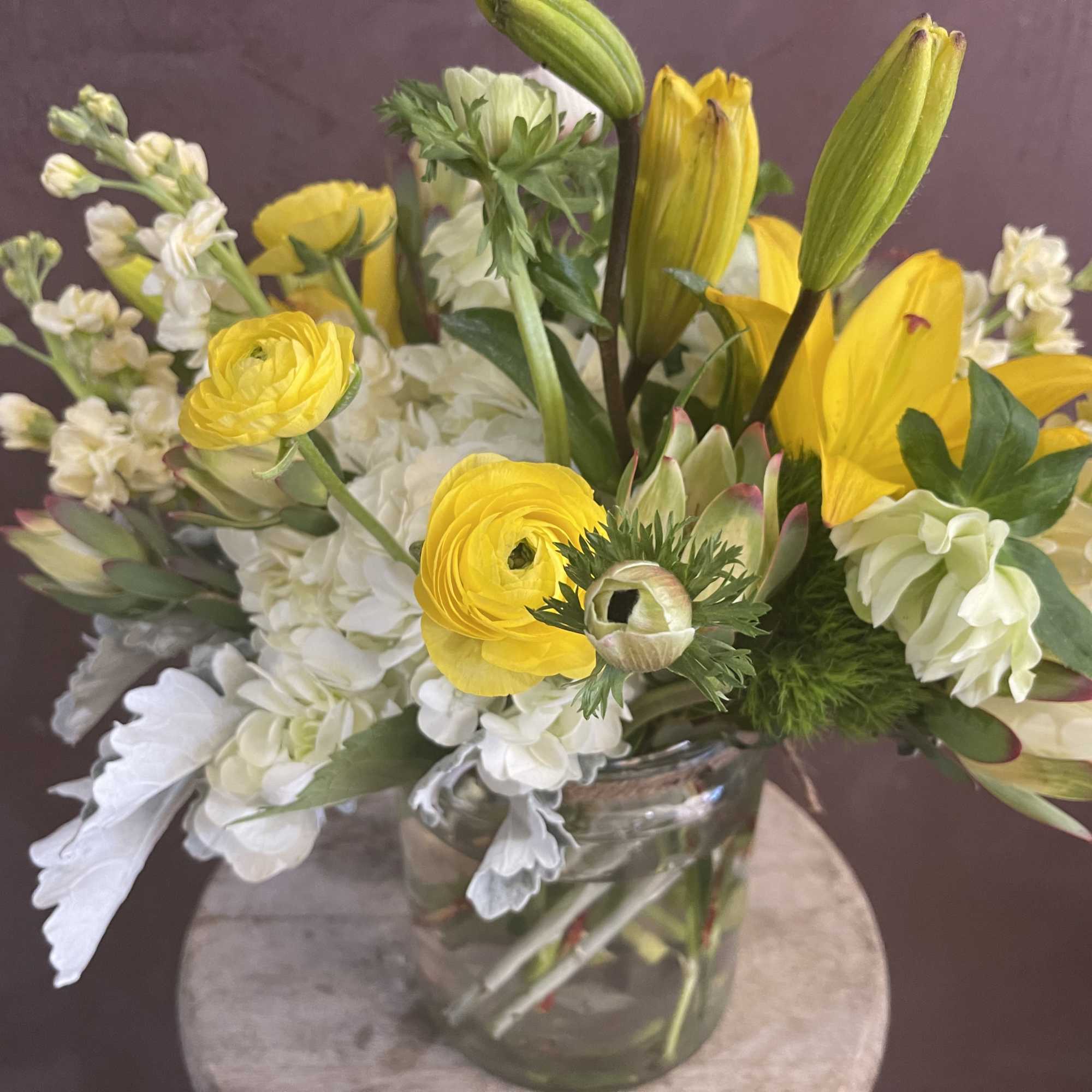 Yellow and white mixed bouquet in a clear glass vase