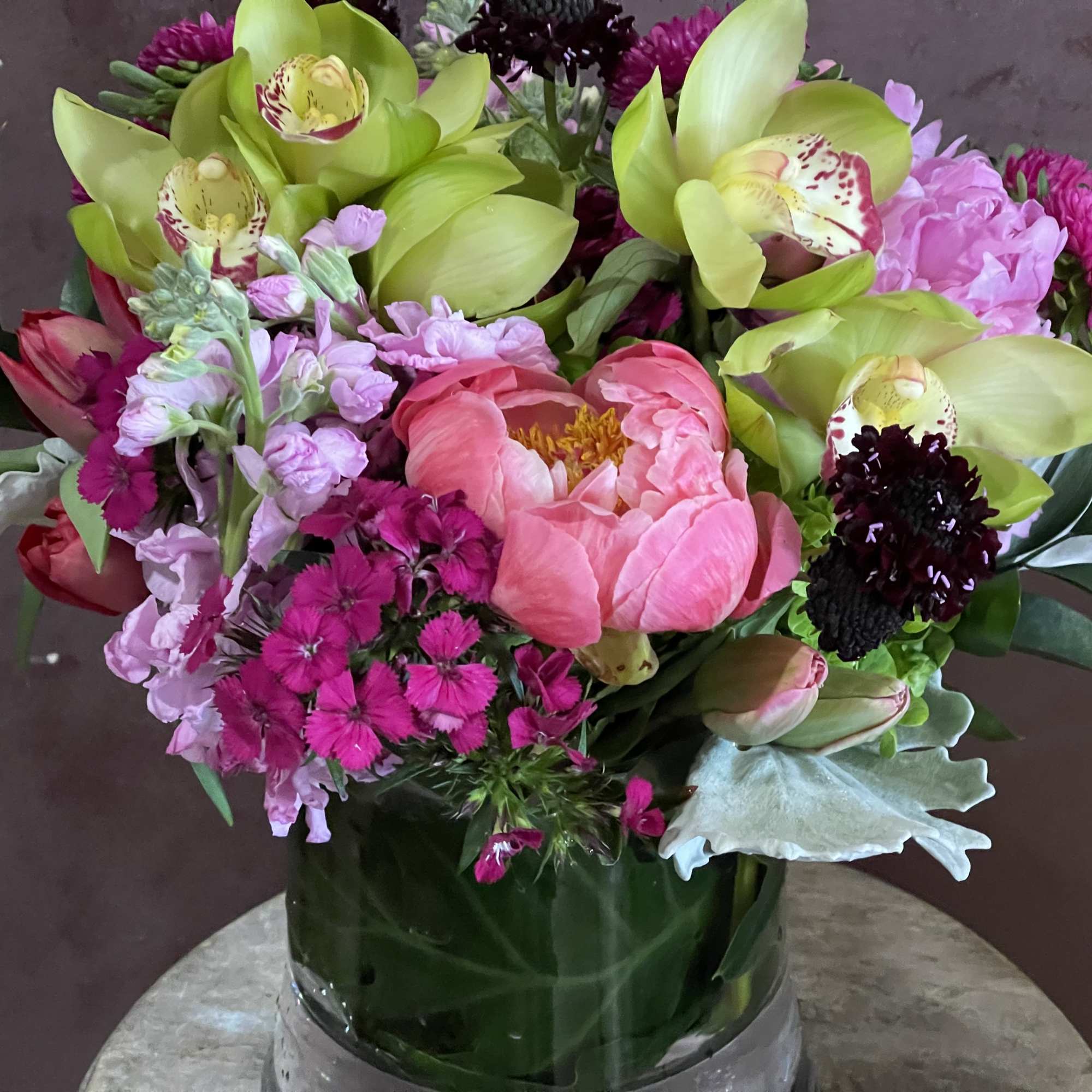 Pink and green mixed bouquet in a glass vase