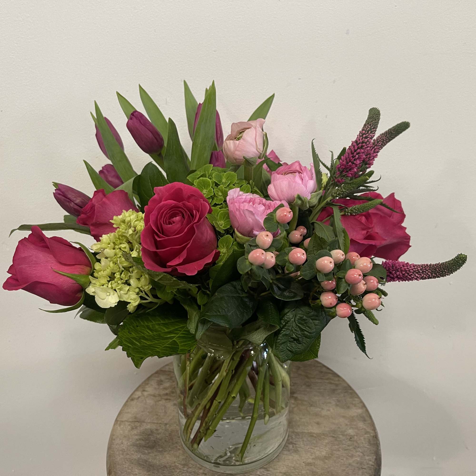 Pink and magenta bouquet in a clear glass vase