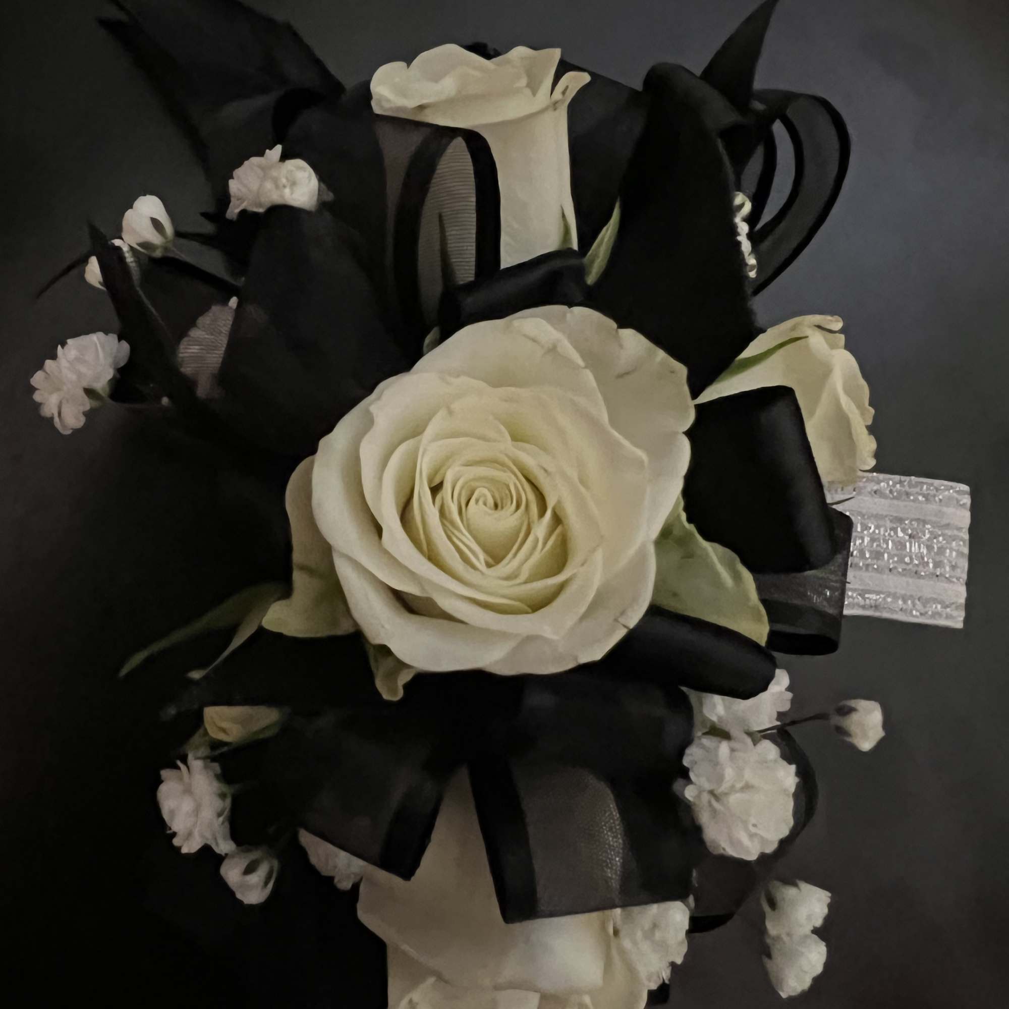 White rose bouquet with black ribbon and small white filler flowers