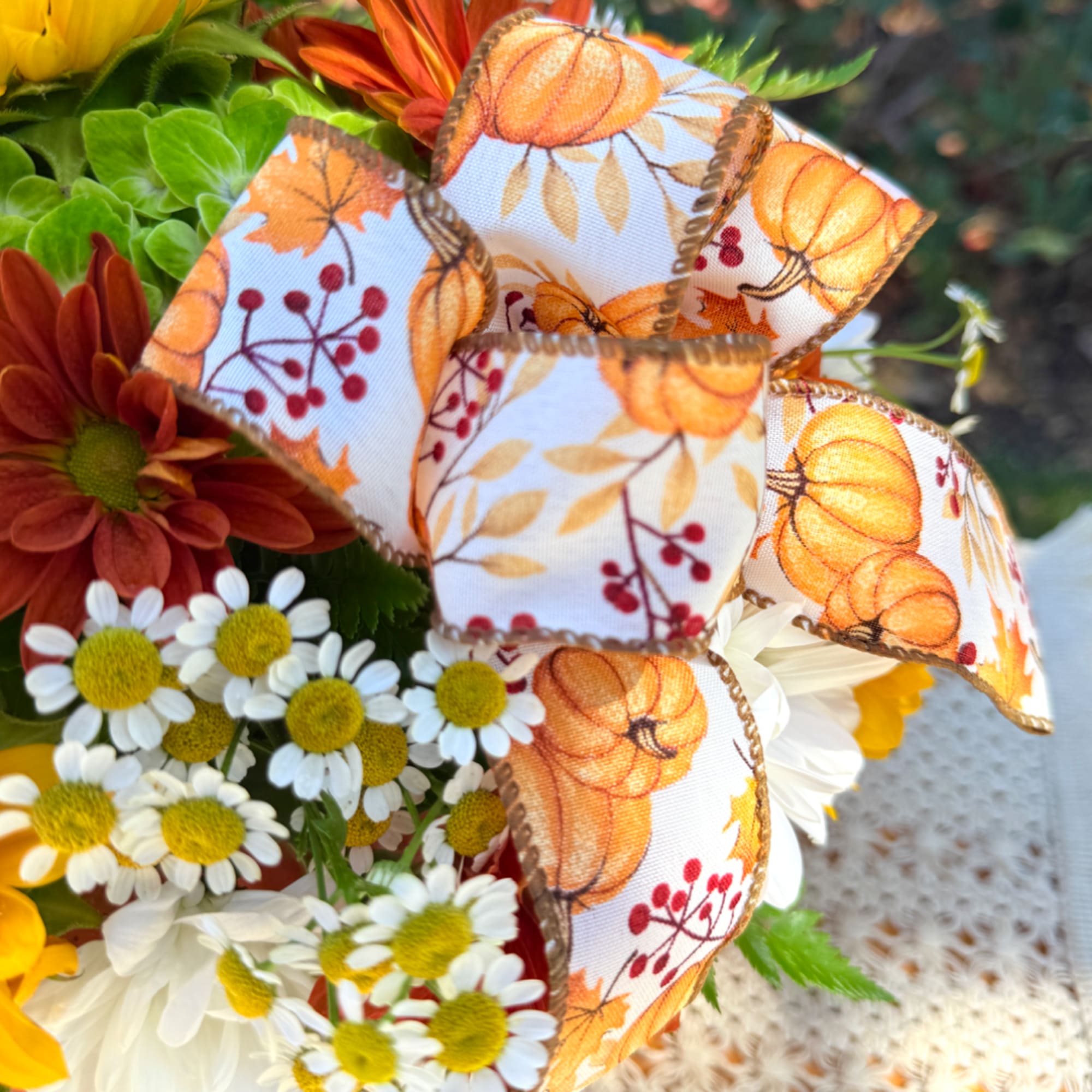 Bouquet of daisies and mums with a pumpkin-pattern ribbon