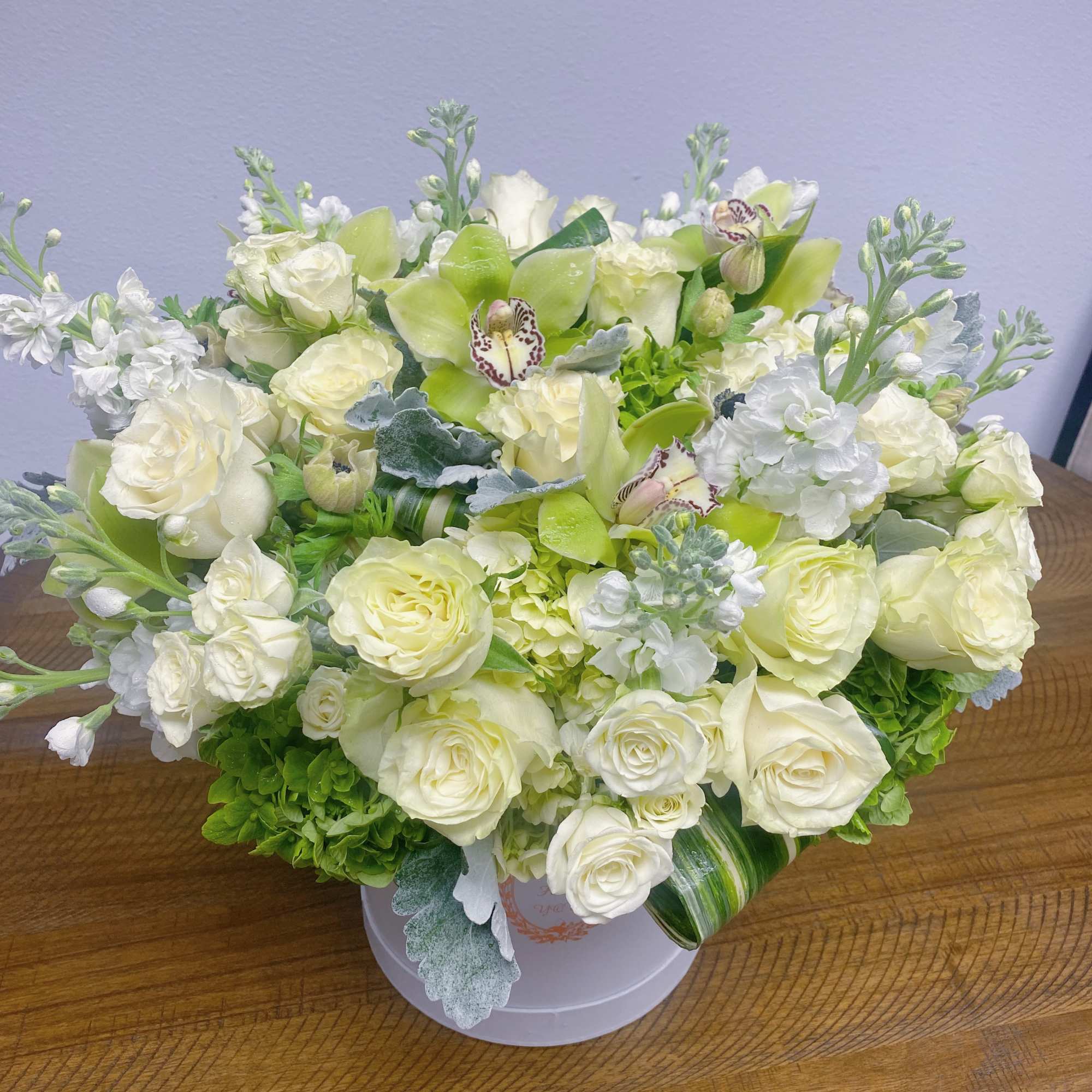 White and pale green floral arrangement in a round box, photo 2 of 3
