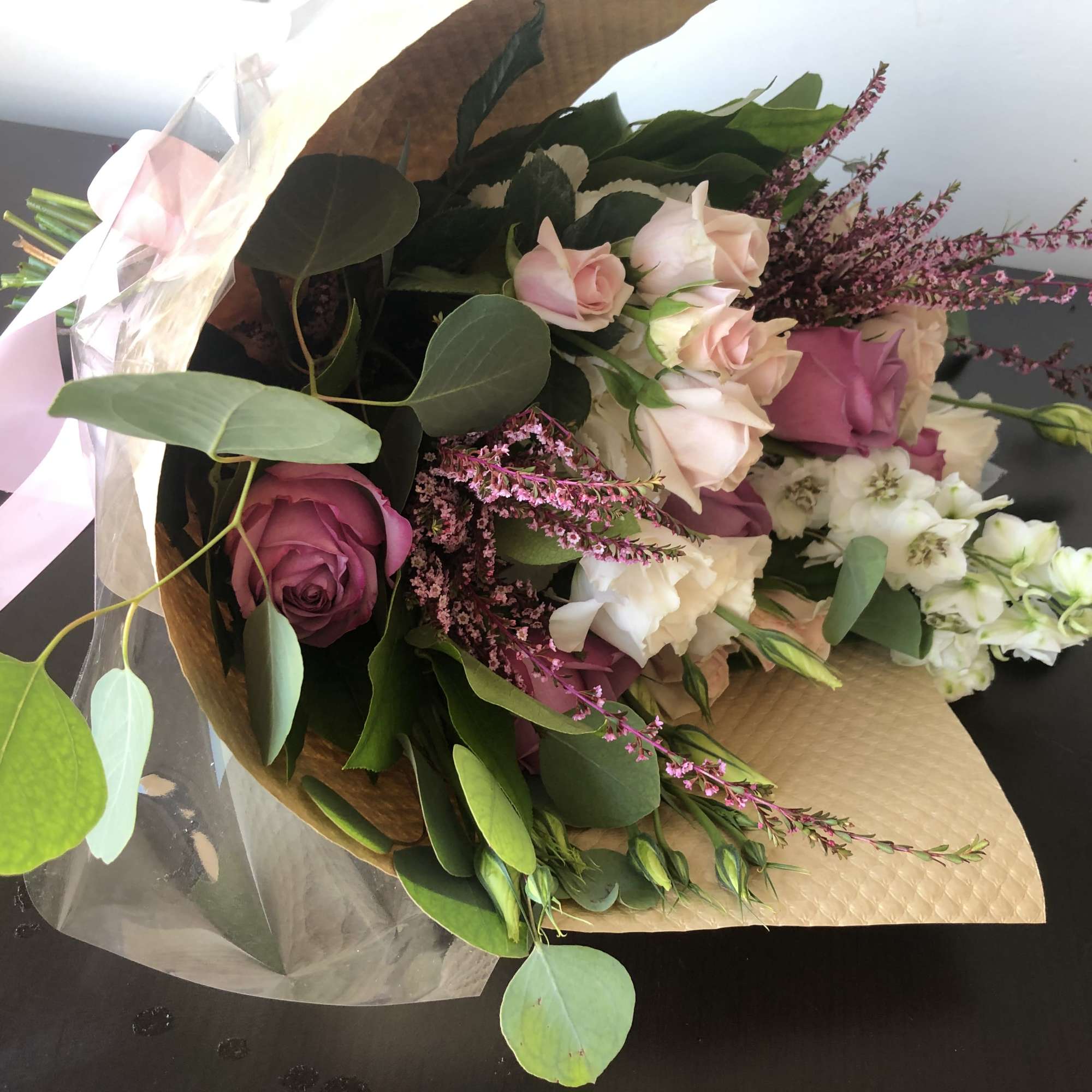 Bouquet of pink and white roses with purple filler flowers