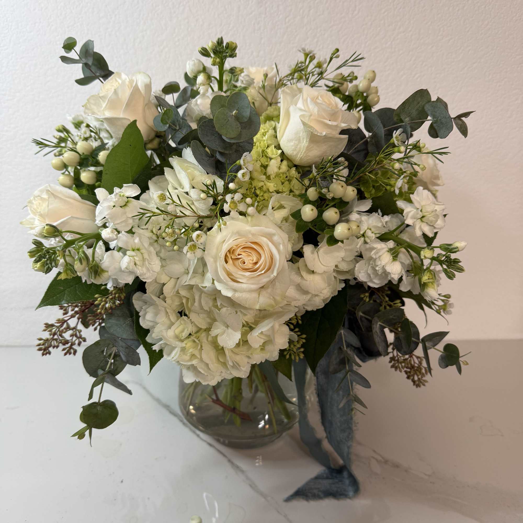 White rose bouquet in a clear glass vase